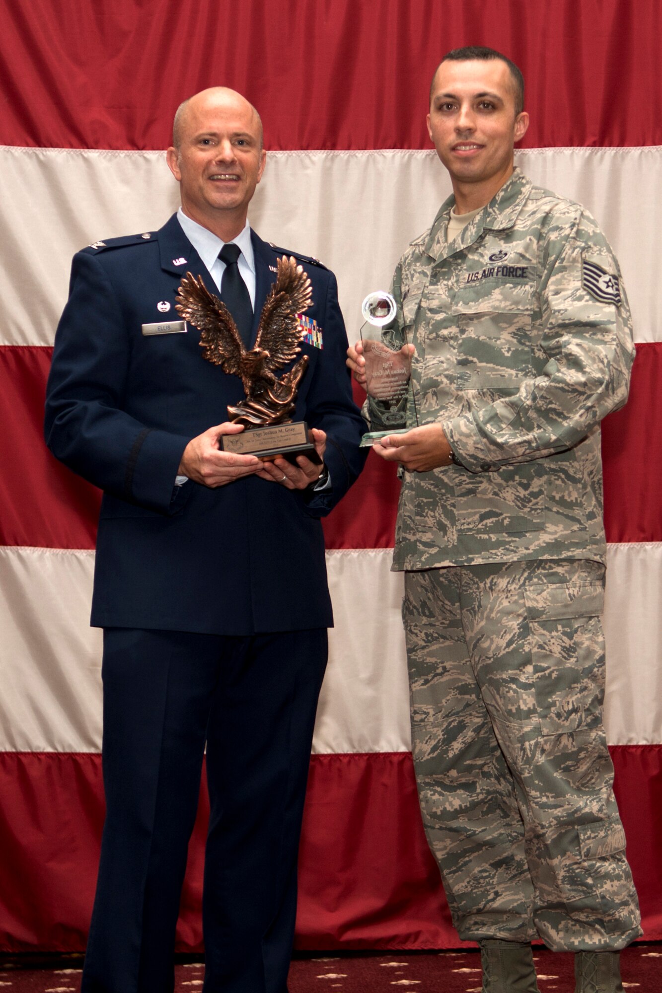U.S. Air Force Col. Jonathan Ellis, 307th Bomb Wing commander, presents Tech. Sgt. Joshua Gray with awards during a Commander's Call, Sept. 9, 2012, Barksdale Air Force Base, La. Gray was selected as the Outstanding Air Reserve Component Intelligence, Surveillance and Reconnaissance Noncommissioned Officer of the Year 2011 for both the 8th Air Force and Air Force Global Strike Command. (U.S. Air Force photo by Staff Sgt. Ted Daigle/Released)