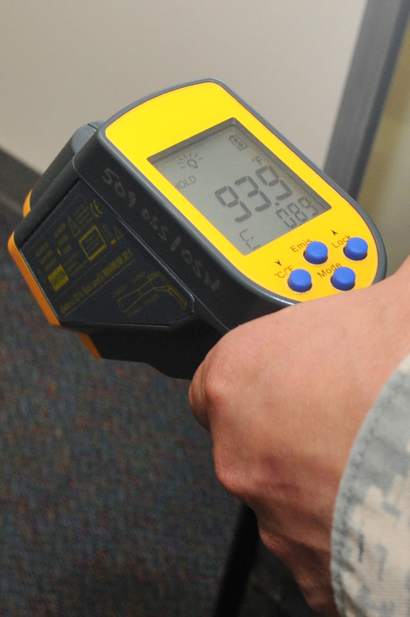 WHITEMAN AIR FORCE BASE, Mo. -- Tech. Sgt. Ryan Watts, 509th Operations Support Squadron, demonstrates an infrared temperature gun during his shift Sept. 13, 2012. The Weather Flight uses the device to take temperature readings and is primarily used in the winter to determine the rate at which snow melts. (U.S. Air Force photo/Heidi Hunt) (Released) 