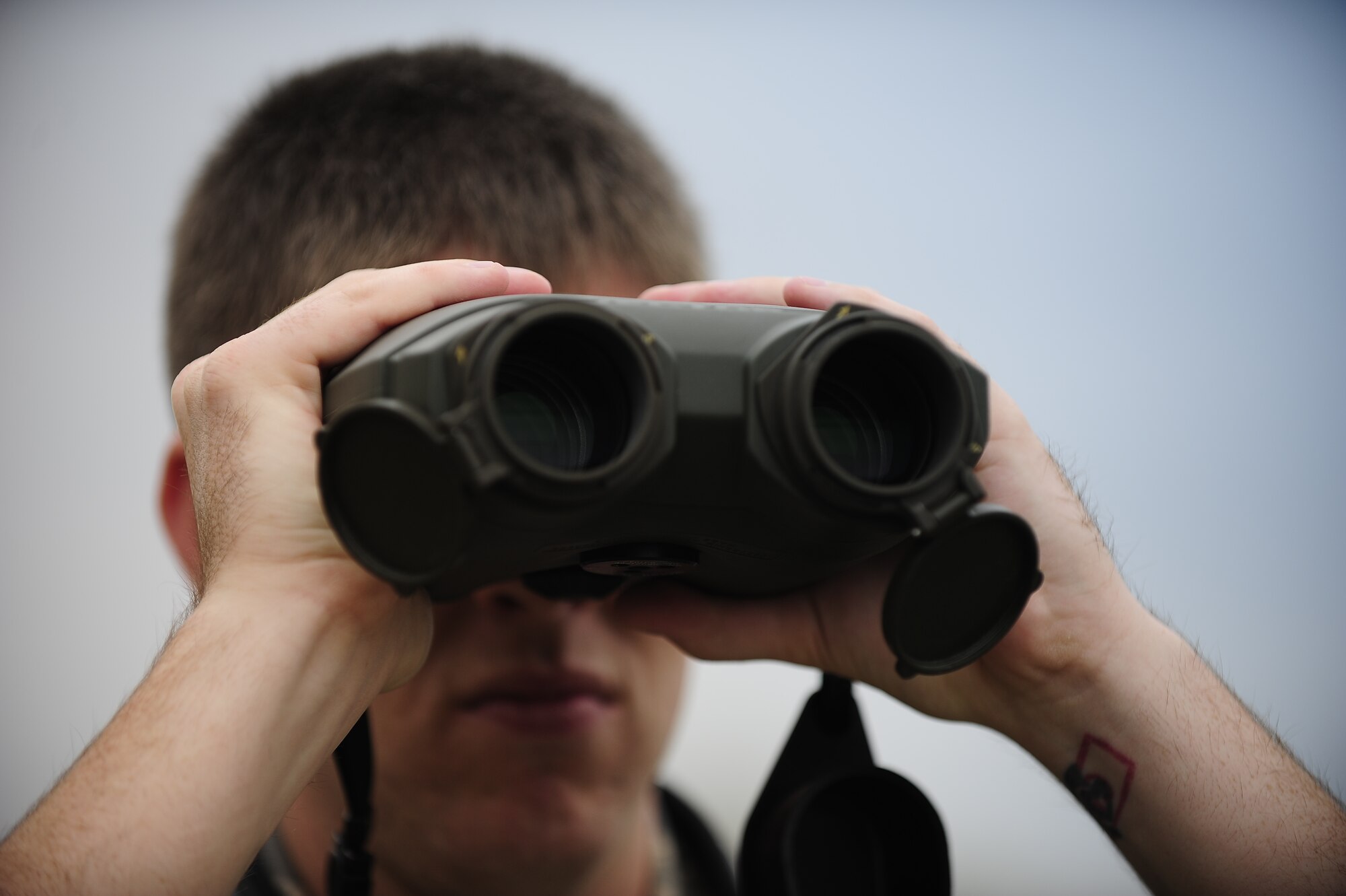 WHITEMAN AIR FORCE BASE, Mo. – Senior Airman Franklyn, 509th Operations Support Squadron weather forecaster, looks through a laser rangefinder to determine the visibility of a certain location Sept. 13, 2012. The binocular-like laser rangefinder is also used to manually detect the height of cloud bases. (U.S. Air Force photo/Heidi Hunt) (Released) 