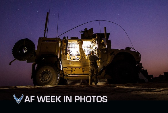 First Lt. Drew Parks grabs equipment from a Mine-Resistant, Ambush-Protected, All-Terrain Vehicle on Sept. 11, 2012, in Southwest Asia. Parks is a joint terminal attack controller with the 82nd Expeditionary Air Support Operations Squadron. (U.S. Air Force photo/Staff Sgt. Jonathan Snyder)  