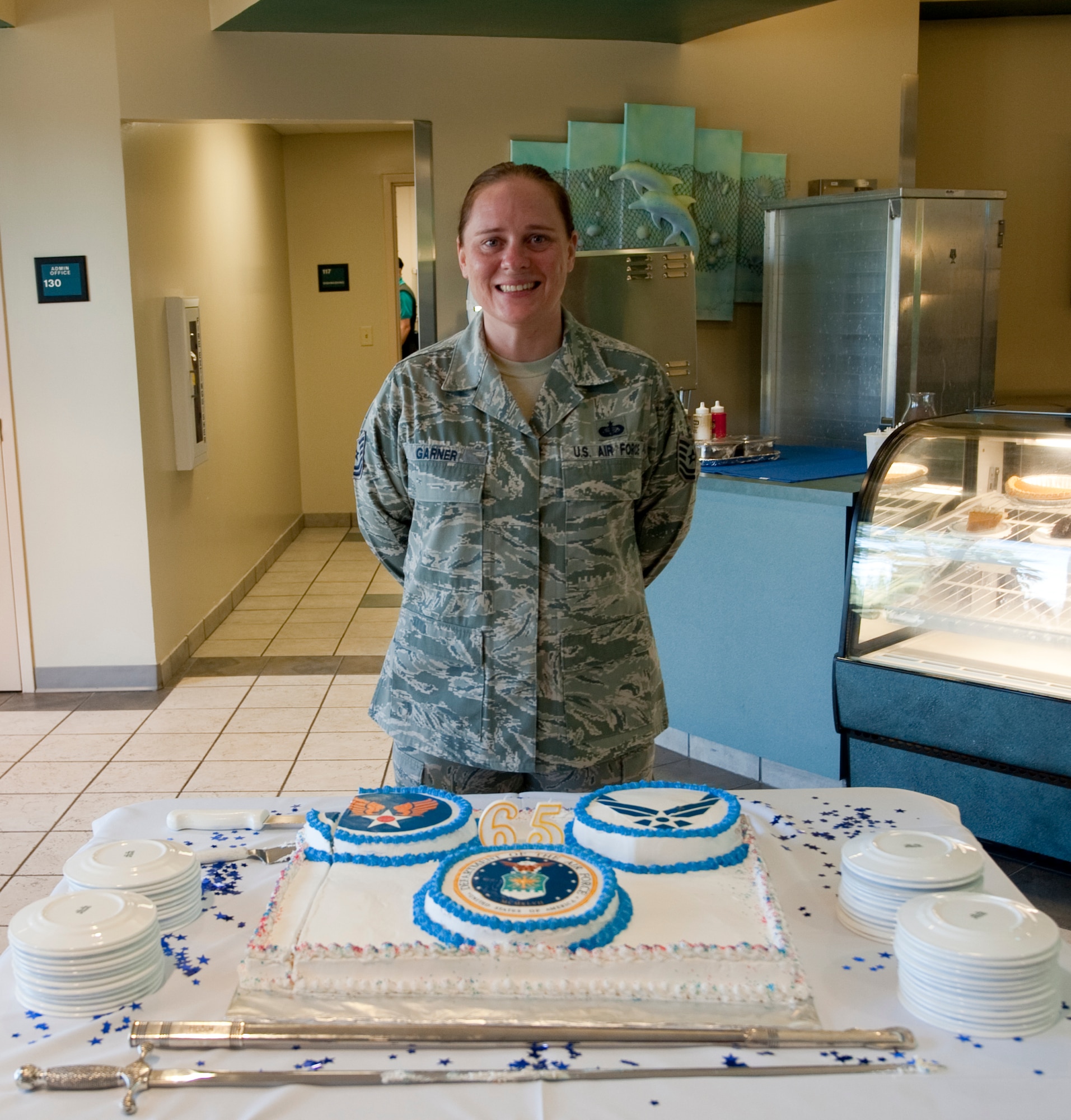 U.S. Air Force Tech. Sgt. Stacy Garner, a unit program manager of 1st Special Operations Force Support Squadron, stands behind a commemorative cake during the U.S. Air Force’s 65th birthday celebration at the Riptide Dining Facility at Hurlburt Field, Fla., Sept. 18, 2012. Garner was tasked with creating a cake design symbolizing the Air Force. (U.S. Air Force Photo/ Airman First Class Nigel Sandridge)