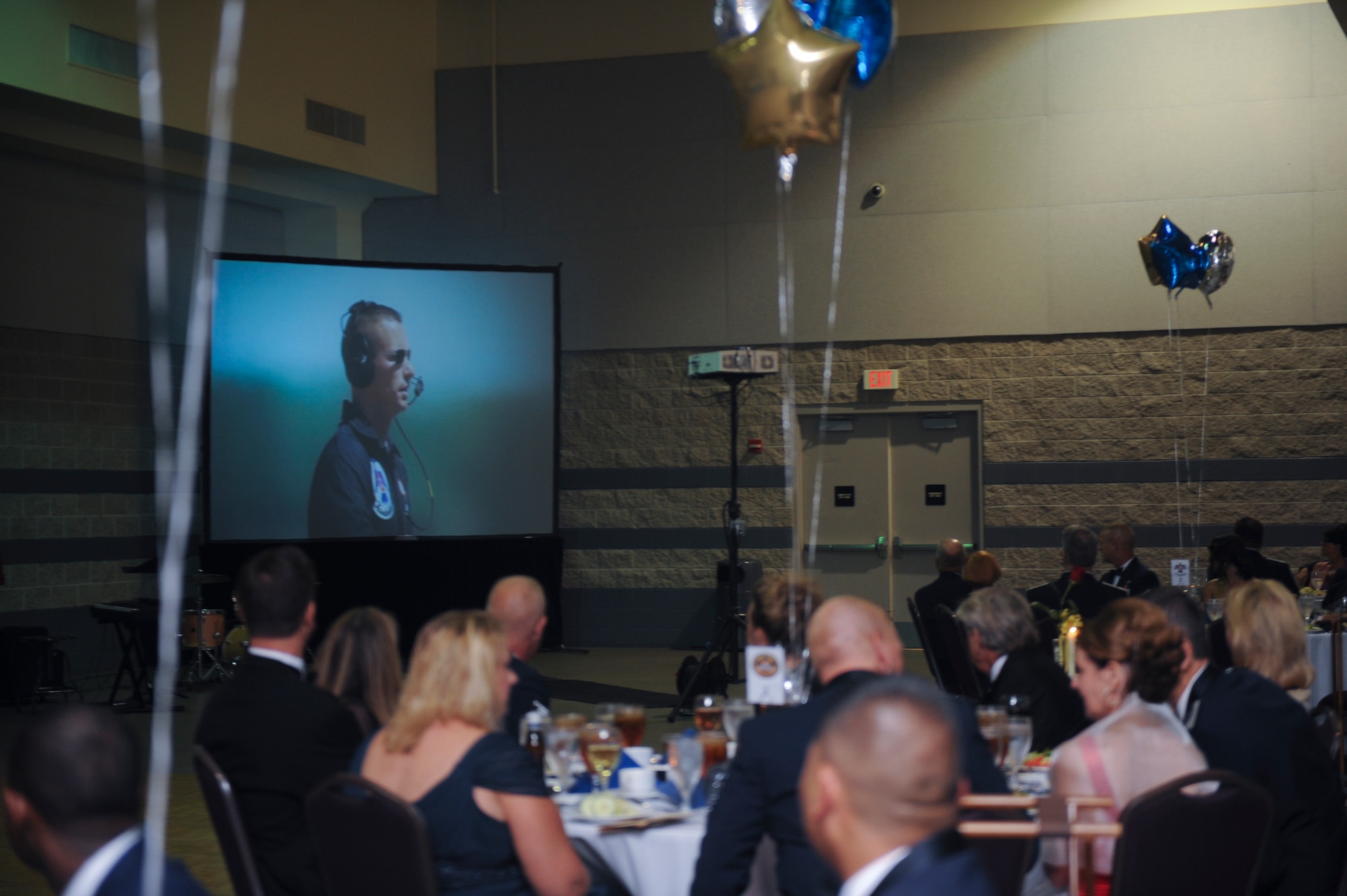 Airmen and guests view a video during the Air Force Ball in Valdosta, Ga., Sept. 14, 2012. The video was a compilation of the Air Force and aviation history. (U.S. Air Force photo by Airman 1st Class Olivia Dominique/Released)