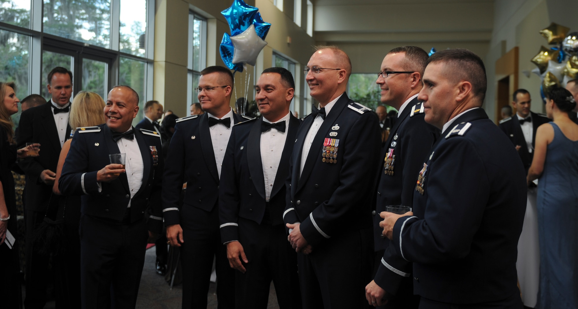 A group of Airmen pose for a photo during social hour at the Air Force Ball in Valdosta, Ga., Sept. 14, 2012. Members of Moody, distinguished visitors, family and friends gathered to celebrate 65 years of Air Force heritage. (U.S. Air Force photo by Airman 1st Class Olivia Dominique/Released)