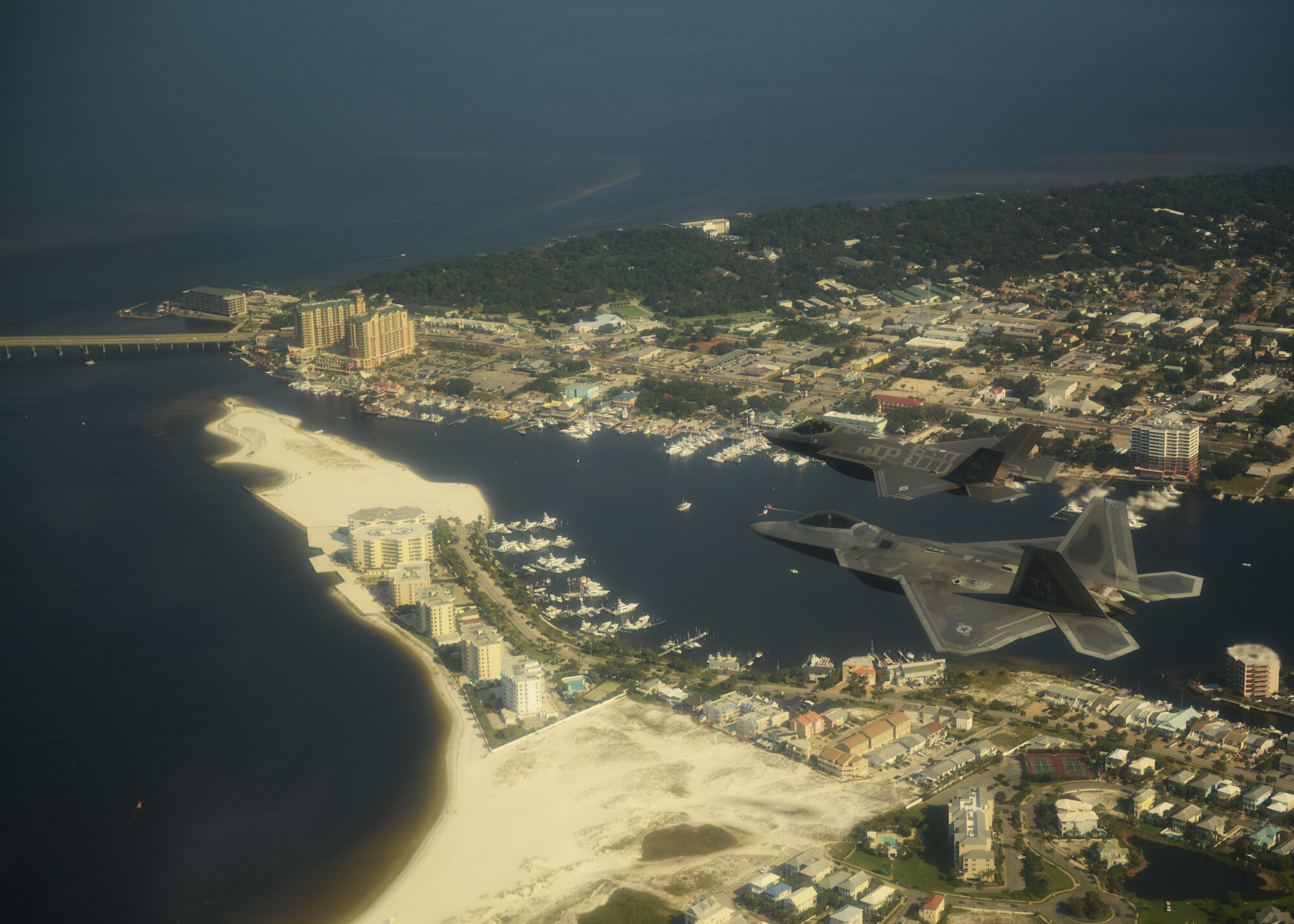 An F-35A Lightning II joint strike fighter from the 33rd Fighter Wing at Eglin Air Force Base, Fla., and an F-22A Raptor from the 325th Fighter Wing at Tyndall Air Force Base, Fla., soar over the Emerald Coast Sept. 19.  This was the first time the two fifth generation fighters have flown together for the Air Force.  (U.S. Air Force photo/Master Sgt. Jeremy T. Lock)