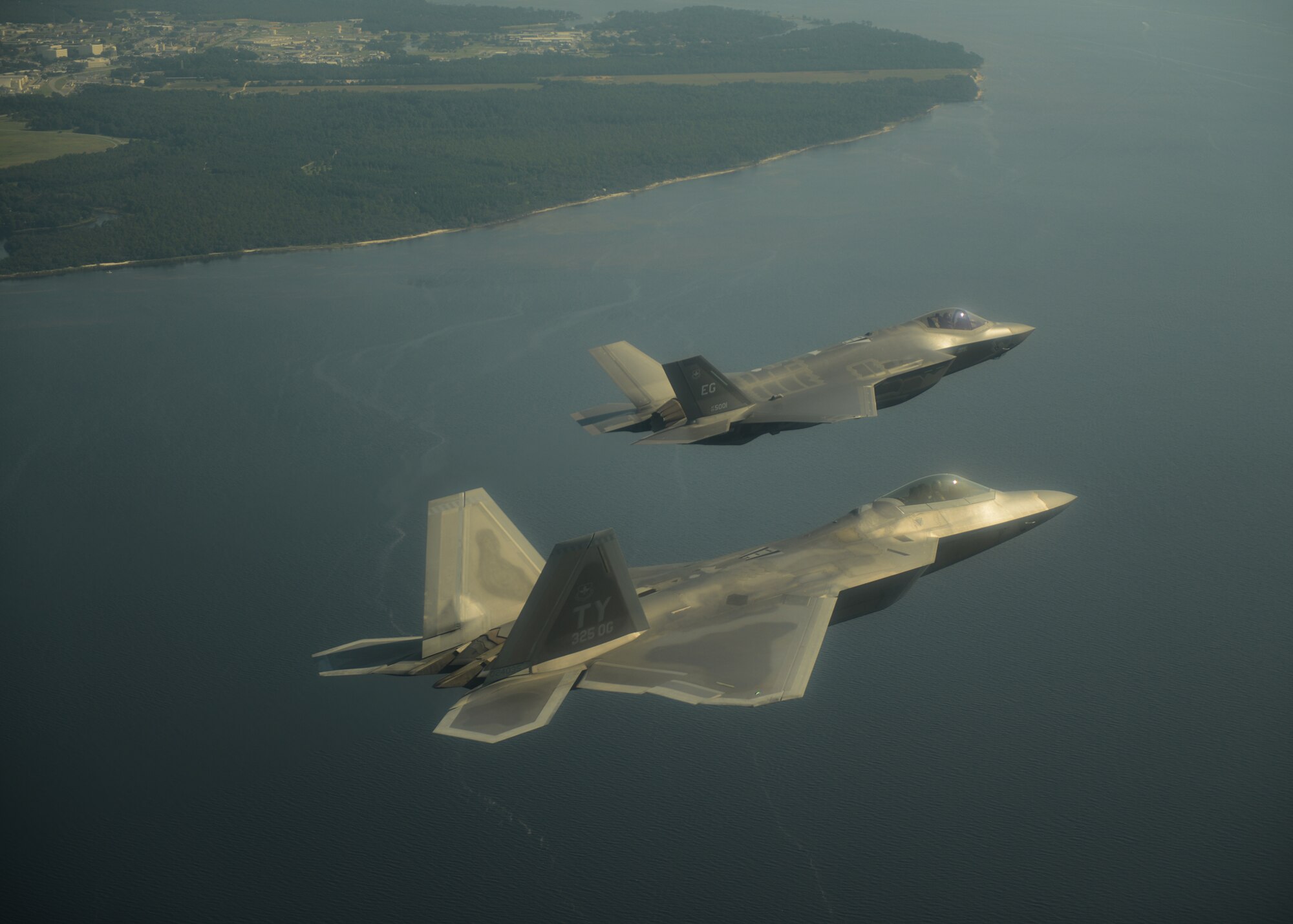 An F-35A Lightning II joint strike fighter from the 33rd Fighter Wing at Eglin Air Force Base, Fla., and an F-22A Raptor from the 325th Fighter Wing at Tyndall Air Force Base, Fla., soar over the Emerald Coast Sept. 19.  This was the first time the two fifth generation fighters have flown together for the Air Force.  (U.S. Air Force photo/Master Sgt. Jeremy T. Lock)