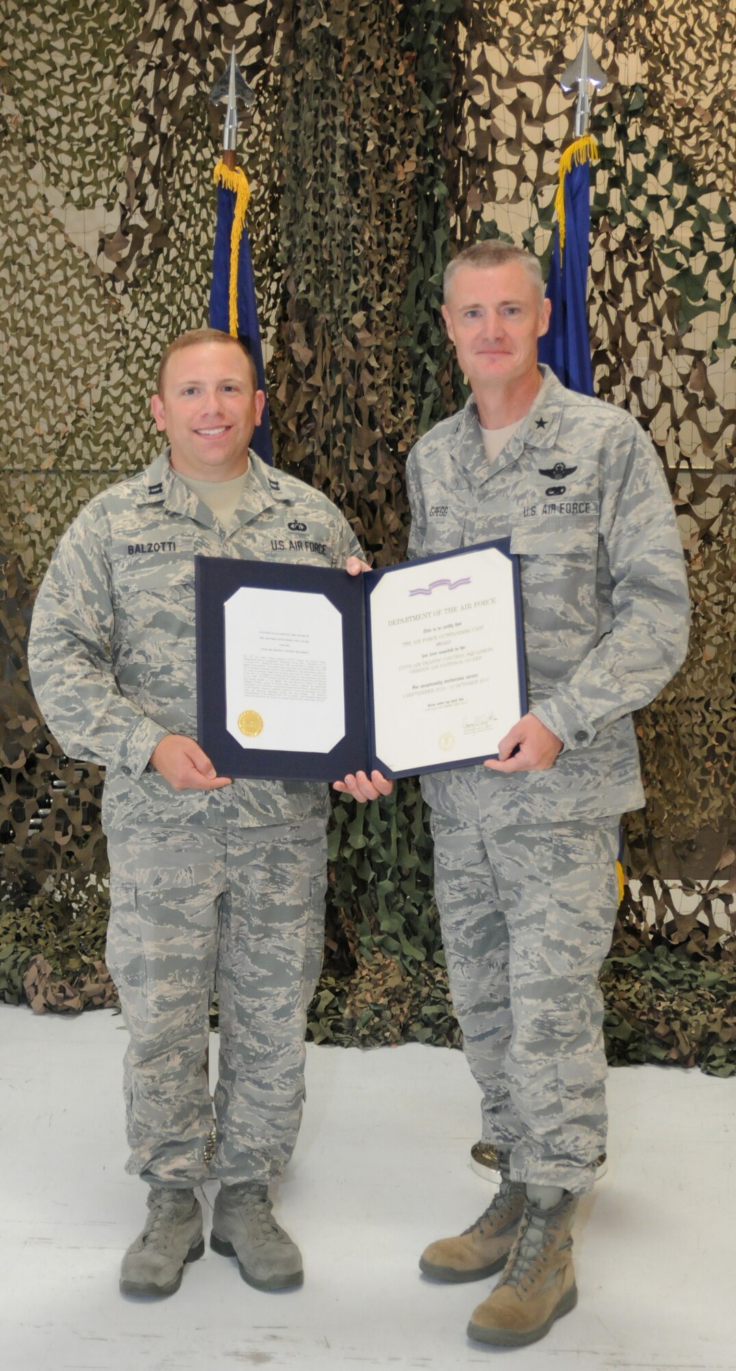 Capt. Michael R. Balzotti, commander of the 270th Air Traffic Control Squadron, accepts the Air Force Outstanding Unit Award on behalf of his unit from Brig. Gen. Steven D. Gregg, commander of the Oregon Air National Guard, at Kingsley Field, Klamath Falls, Ore., Aug. 4, 2012. (Oregon Air National Guard photo by Tech. Sgt. Jefferson Thompson, 173rd Fighter Wing Public Affairs/released)

