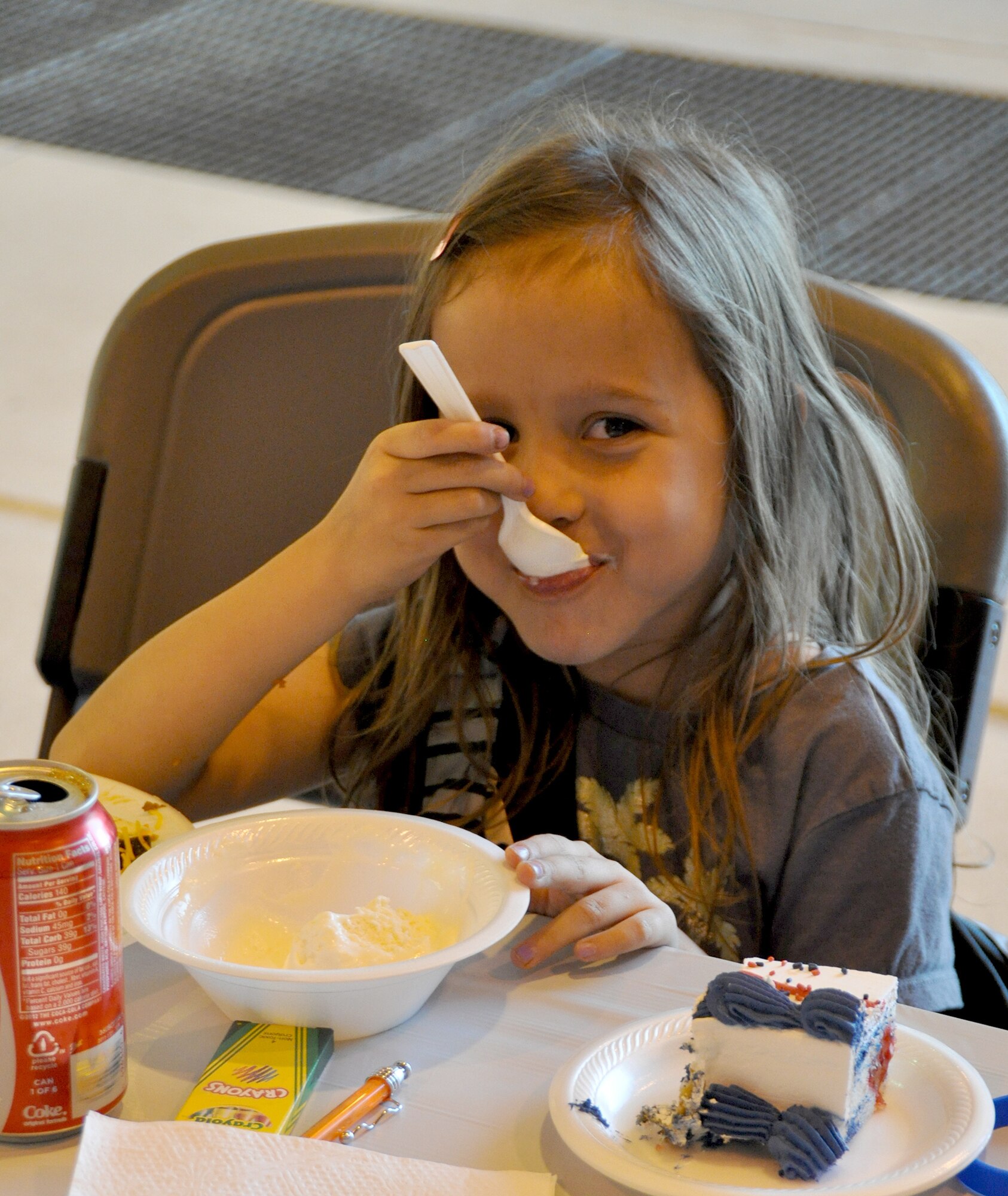 Chloe satisfies her sweet tooth during the Peterson Air Force Base Deployed Family Dinner, sponsored by the Air Force Reserve Command's 302nd Airlift Wing and its active duty associate unit, the 52nd Airlift Squadron. Approximately 100 family members of deployed personnel from throughout Peterson AFB, Colo. attended the Sept 14, 2012 event held in the 302nd AW aircraft maintenance hangar. Chloe's father is Master Sgt. Leo Morales of the 721st Communication Squadron. (U.S. Air Force photo/Tech. Sgt. Daniel Butterfield)