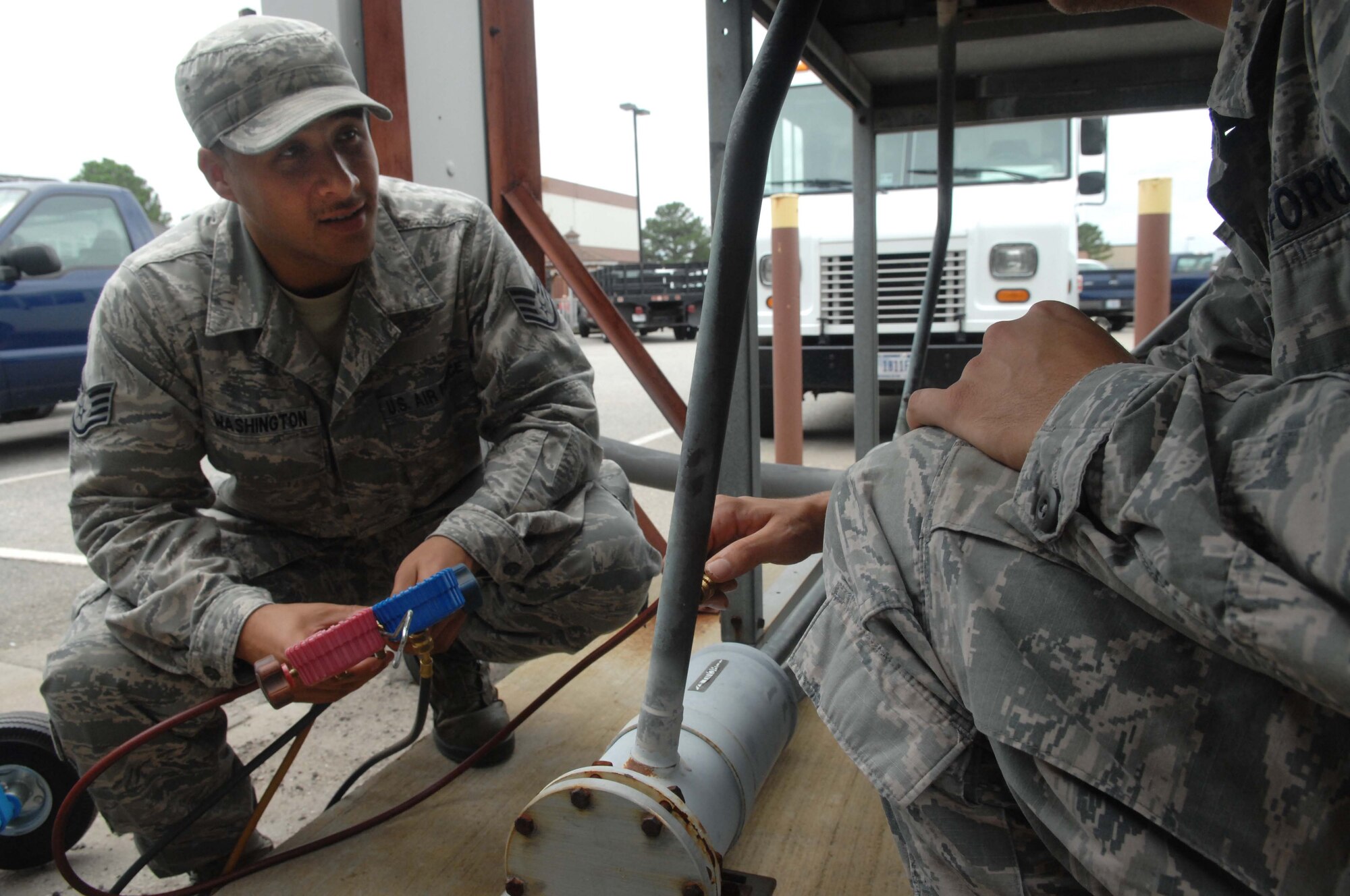 Staff Sgt. Aaron Washington (left) and Senior Airman Kevin Gillaspie, 633rd Civil Engineer Squadron heating, ventilation and air conditioning technicians, check the pressure on an HVAC system, Sept. 18, 2012, at Langley Air Force Base, Va. Data from this system can be tracked in one of the “legacy” systems used by the 633rd CES. (U.S. Air Force photo by Airman 1st Class Austin C. Harvill/Released)