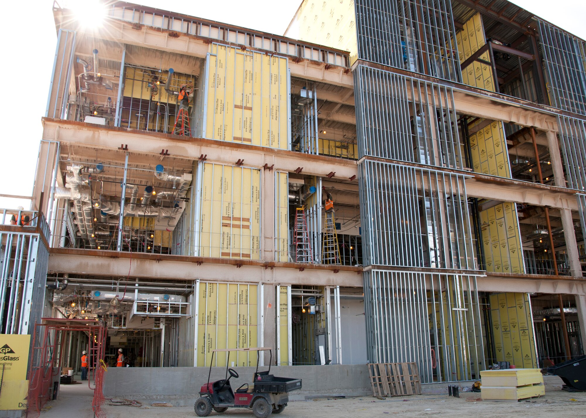 Construction workers install electrical wires and air conditioner ducts in the Wilford Hall Ambulatory Surgical Center A wing on Joint Base San Antonio-Lackland, Texas, Aug. 28. The wing is part of the first phase of the WHASC construction project, which includes a 1,000-car parking garage and a new energy plant that is nearly 67 percent completed. (U.S. Air Force photo/Senior Airman Kevin Iinuma)