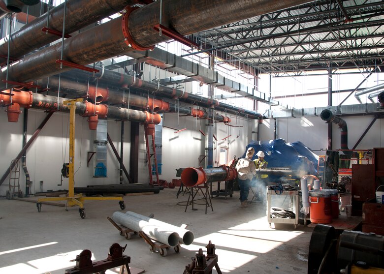 Construction workers prepare pipes for the new energy plant on Joint Base San Antonio-Lackland, Texas, Aug. 28. The energy plant is part of the first phase, which includes a 1,000-car parking garage and the "A" wing of the new Wilford Hall Ambulatory Surgical Center. The state-of-the-art medical facility is projected to be completed in 2015. (U.S. Air Force photo/Senior Airman Kevin Iinuma)