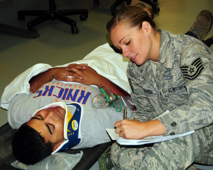 Tech. Sgt. Julianna Lindstrom 914th Aero Patient Staging Squadron, Medical Technician is obtaining patient medical history and documenting vital signs during a recent mass causality exercise which involved a multiple vehicle collision at the Niagara Falls Air Reserve Station, NY on September 9, 2012. The exercise was conducted to test the medical readiness and skills of the unit during an emergency. This exercise is an annual requirement for the ASTS. (US Air Force photo by Peter Borys)