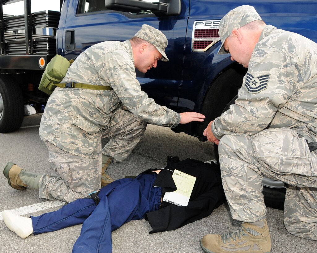 Captain James Bastian, 914th Airlift Wing Chaplain (left) administers emergency religious ministrations to a simulated deceased person with Tech. Sgt. Terry Jones, 914th Airlift Wing Chaplain Assistant during a recent mass causality exercise which involved a multiple vehicle collision at the Niagara Falls Air Reserve Station, NY on September 9, 2012. The exercise was conducted to test the medical readiness and skills of the unit during an emergency. This exercise is an annual requirement for the ASTS. (US Air Force photo by Peter Borys)