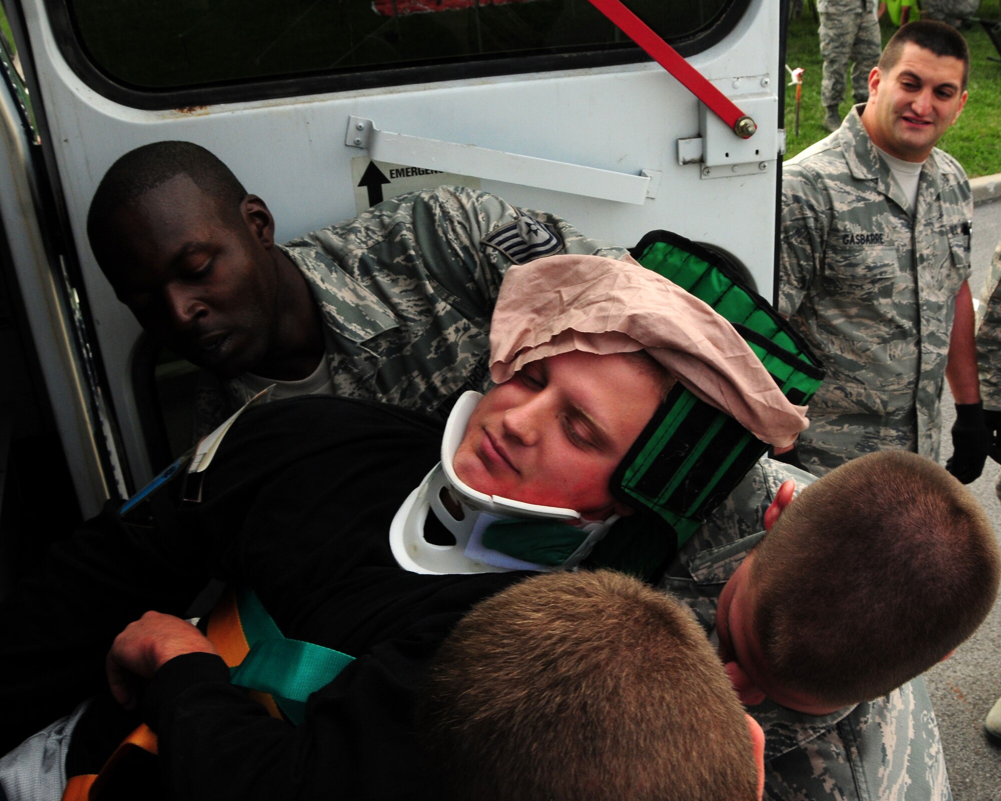 914th Aero Patient Staging Squadron members carry a patient who has suffered simulated back and neck injuries for transfer during a recent mass causality exercise which involved a multiple vehicle collision at the Niagara Falls Air Reserve Station, NY on September 9, 2012. The exercise was conducted to test the medical readiness and skills of the unit during an emergency. This exercise is an annual requirement for the ASTS. (US Air Force photo by Peter Borys)