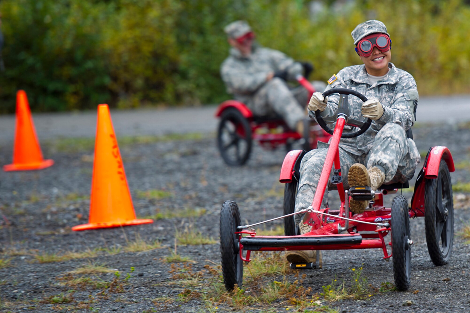 Pfc. Victoria Giltug, 84th Engineer Support Company, of Colonia, Micronesia, steers a pedal vehicle with Drunk Busters goggles simulating the visual impairment of a drunk driver. (U.S. Air Force photo/Justin Connaher)