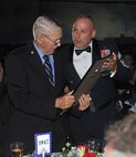 78th Air Base Wing Command Chief Master Sgt. Patrick Bowen presents a plaque and letter of appreciation to retired Master Sgt. Clyde Mathe, a World War II veteran. At 19, Mathe enlisted in the Army Air Forces. During his 28 years of service, Mathe was stationed across the United States, and in  Guam, Japan and England. His final duty station was Robins.  (U.S. Air Force photo/ Tommie Horton)