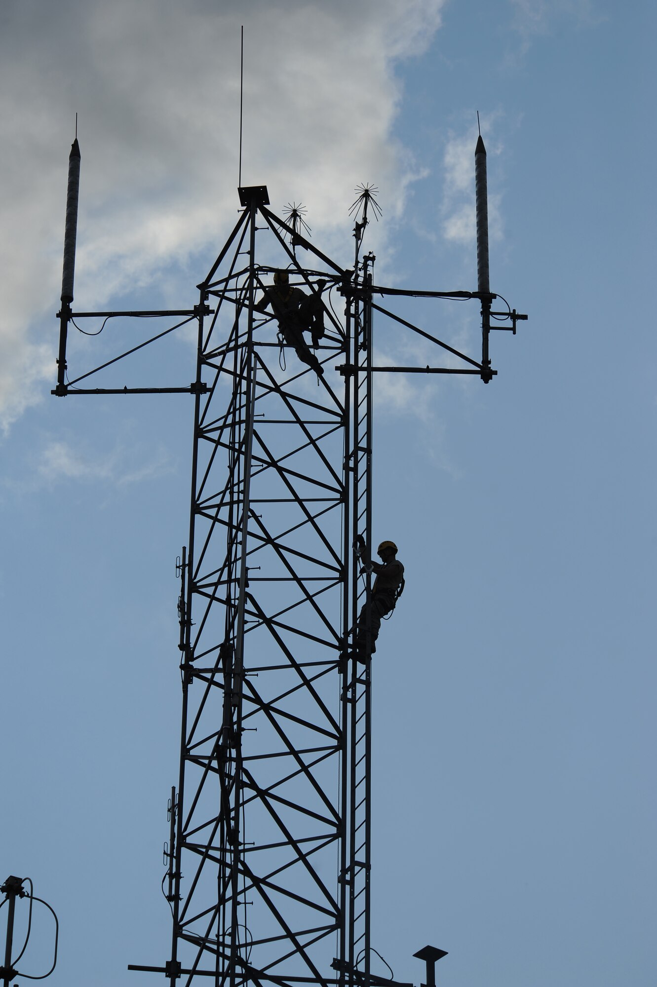 Airman 1st Class Creston Jenkins, top, and Senior Airman David Montroy both members of the 2nd Communications Squadron, scale an antenna tower on Barksdale Air Force Base, La., Sept. 18. The Cable Dawgs Airmen climbed the tower to inspect the tower's antennas. Every six months the antennas are inspected to ensure the wires connected to the antennas do not have any corrosion or damage. (U.S. Air Force photo/Senior Airman Micaiah Anthony)(RELEASED) 