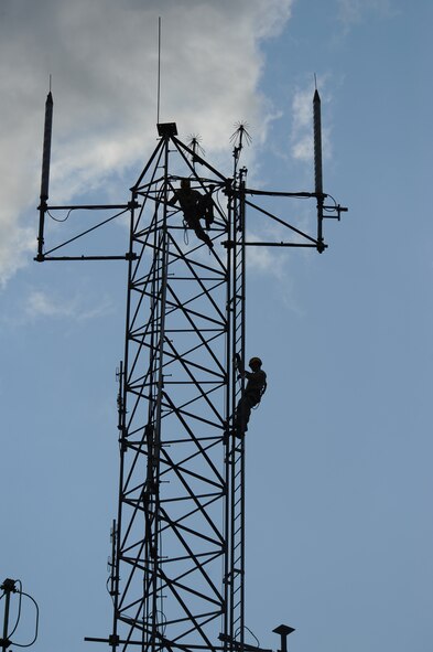 Airman 1st Class Creston Jenkins, top, and Senior Airman David Montroy both members of the 2nd Communications Squadron, scale an antenna tower on Barksdale Air Force Base, La., Sept. 18. The Cable Dawgs Airmen climbed the tower to inspect the tower's antennas. Every six months the antennas are inspected to ensure the wires connected to the antennas do not have any corrosion or damage. (U.S. Air Force photo/Senior Airman Micaiah Anthony)(RELEASED) 