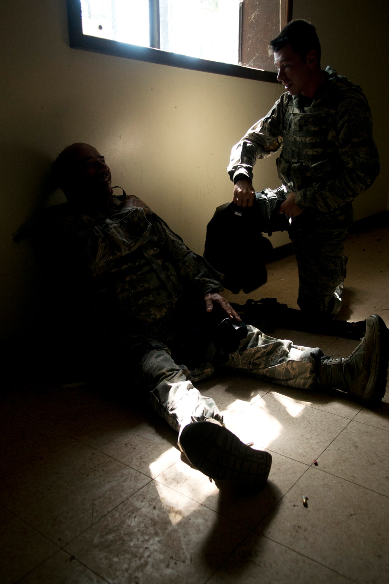 U.S. Air Force Tech. Sgt. David Fuselier and Senior Airman Clint Melancon, both members of the 307th Security Forces Squadron, take a break following a building search training scenario during practice for the Global Strike Challenge, Sept. 7, 2012, Barksdale Air Force Base, La. In the scenario, Fuselier played the role of an aggressor "active shooter" while Melancon (kneeling) and his team searched for him throughout the building, finding and stopping him. (U.S. Air Force photo by Master Sgt. Greg Steele/Released)