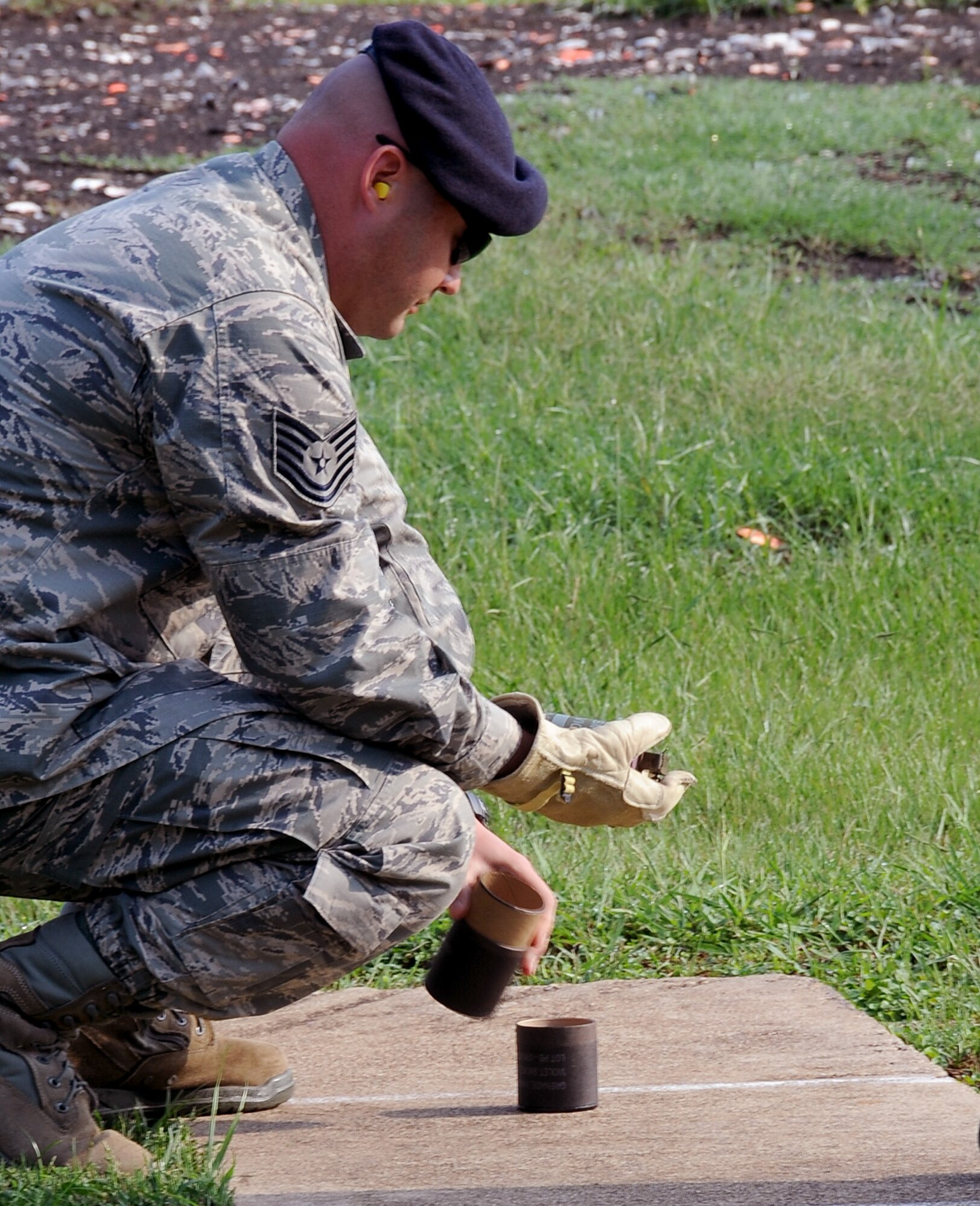 Tech. Sgt. Aaron Lesher, 2nd Security Forces Squadron, takes out an M-18 smoke grenade during training at the 2nd Civil Engineer Squadron Explosive Ordnance Disposal facility on Barksdale Air Force Base, La., Sept. 18. EOD technicians taught 11 Barksdale personnel how to safely handle, employ and operate pyrotechnic devices as well as misfire procedures and emergency actions. (U.S. Air Force photo/Staff Sgt. Amber Ashcraft)(RELEASED)