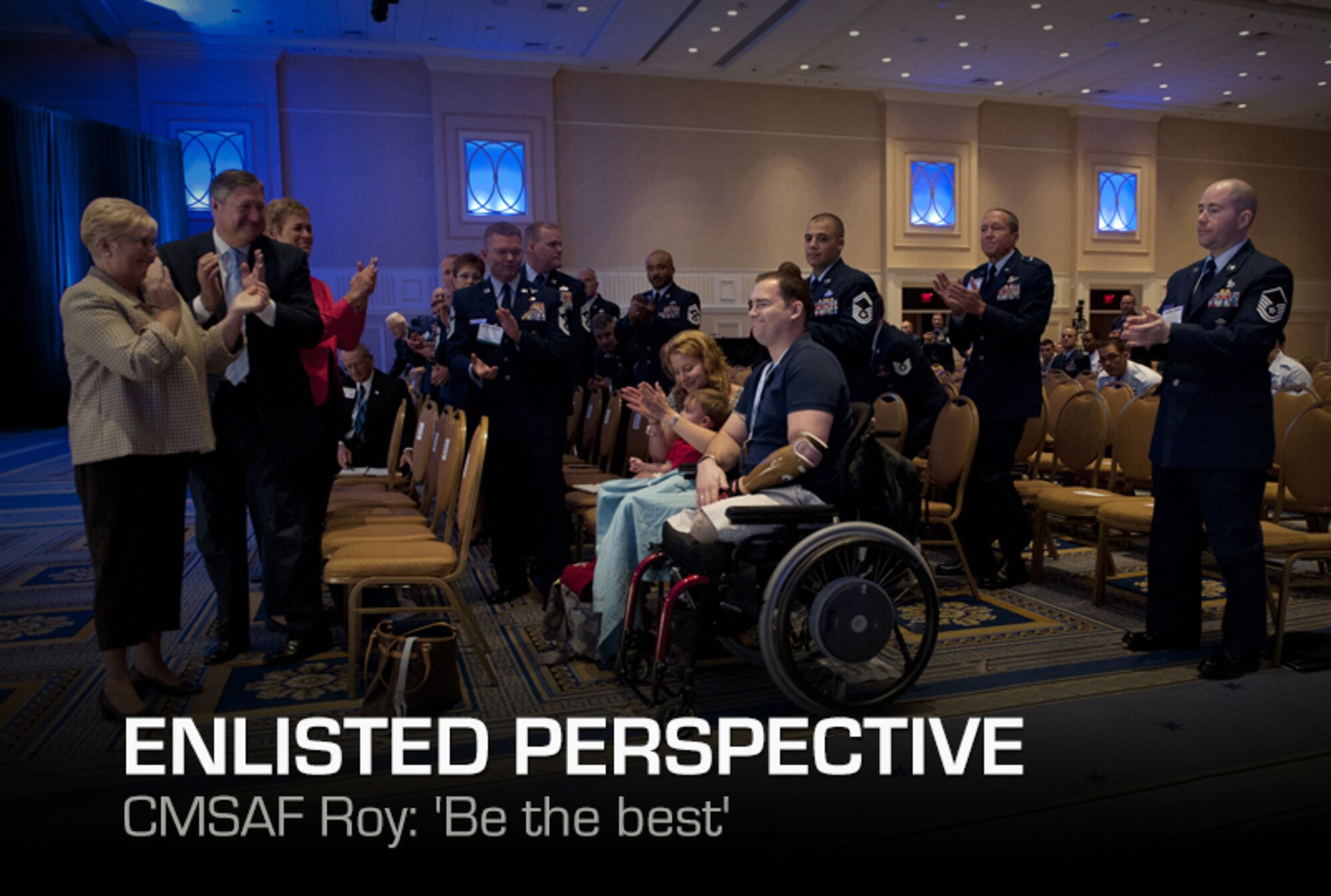 Tech. Sgt. Joe Deslauriers, center, his son, Cameron, and wife, Lisa, are applauded by the crowd during the enlisted call of Air Force Association's Air and Space Conference and Technology Exposition in Washington, Sept. 19, 2012. Deslauriers, who is an explosives ordnance technician assigned to the 1st Special Operations Civil Engineer Squadron, Hurlburt, Fla., lost both legs in Afghanistan last year. To the left is Paula Roy; wife of CMSAF Roy; Secretary of the Air Force Michael B. Donley and his wife, Gail. (U.S. Air Force photo by Val Gempis)