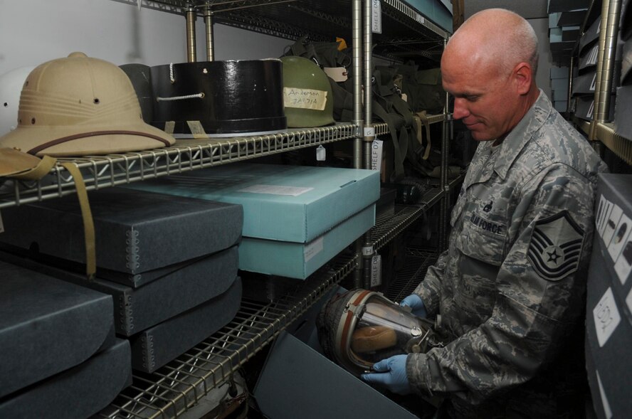 Master Sgt. Eric Grim, 28th Bomb Wing South Dakota Air and Space Museum curator, places a MA-2 flight helmet in a storage bin at the SDA&SM in Box Elder, S.D., Sept. 14, 2012. The MA-2 flight helmet was used in flights above 50,000 feet during the 1950s. The museum houses a wide variety of military artifacts, uniforms and historical documents received from donors around the globe on display. (U.S. Air Force photo by Airman 1st Class Anania Tekurio/Released)