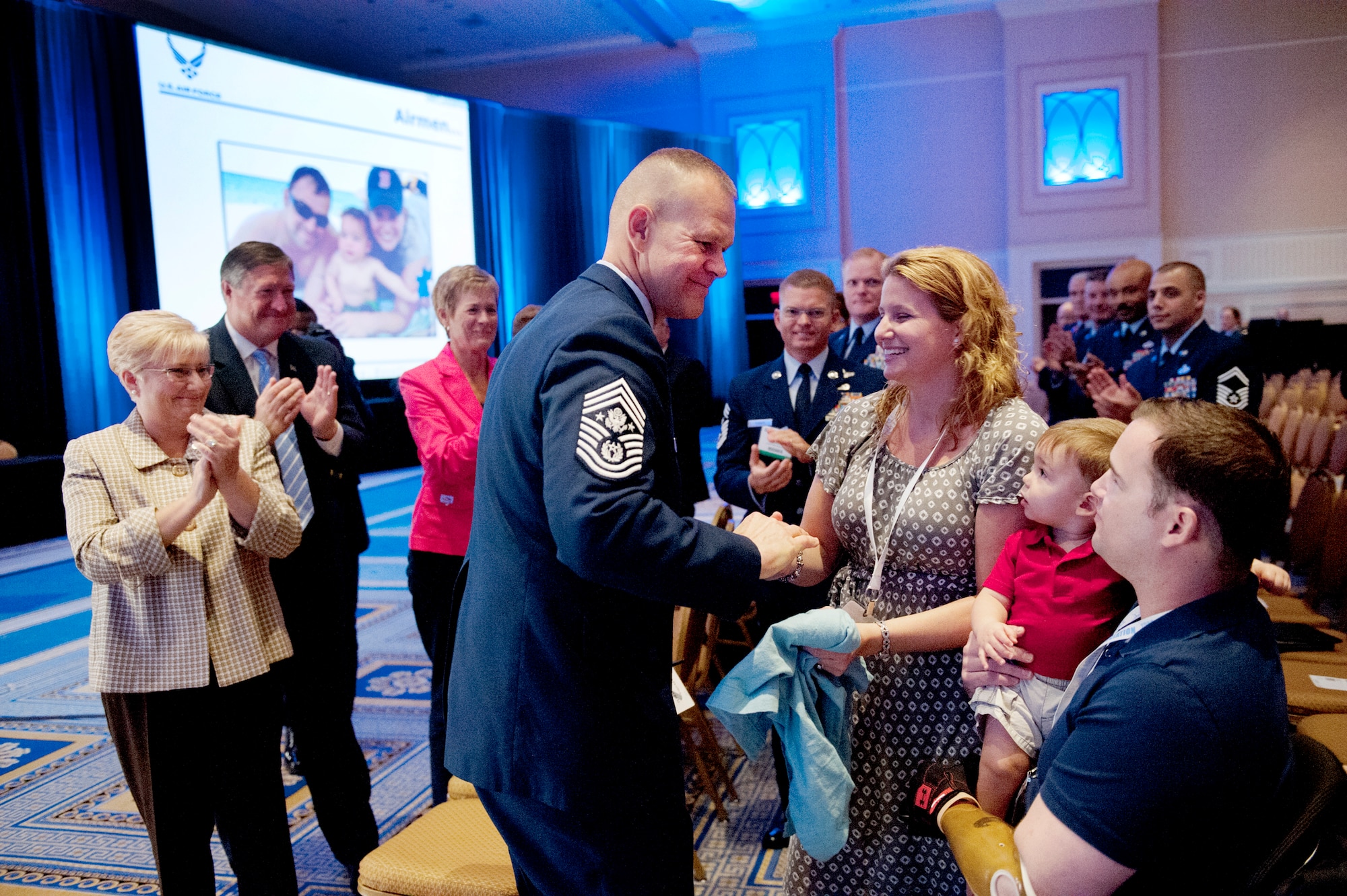 Chief Master Sgt. of the Air Force James A. Roy, center, greets Tech. Sgt. Joe Deslauriers, right, his son, Cameron, and wife, Lisa, during the enlisted call of the Air Force Association's Air and Space Conference and Technology Exposition in Washington, Sept. 19, 2012. Deslauriers, who is an explosives ordnance technician assigned to the 1st Special Operations Civil Engineer Squadron, Hurlburt, Fla., lost both legs in Afghanistan last year. To the left is Paula Roy; wife of CMSAF Roy; Secretary of the Air Force Michael B. Donley and his wife, Gail. (U.S. Air Force photo by Val Gempis)