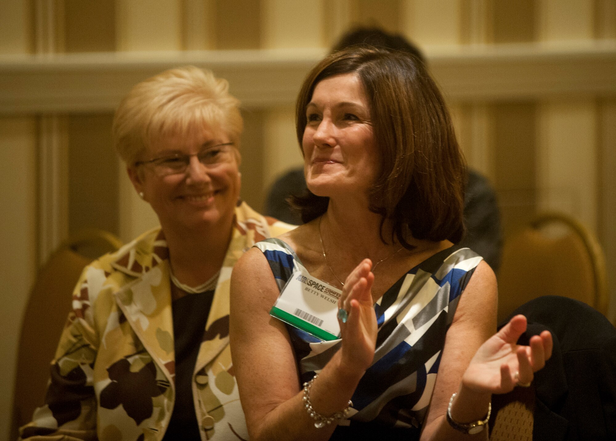 Betty Welsh, wife of Air Force Chief of Staff Gen. Mark A. Welsh III, applauds as she listens to a speaker during the Air Force Association Family Forum in Washington, D.C., Sept. 17, 2012. Beside her is Paula Roy, the wife of Chief Master Sgt. of the Air Force James Roy. (U.S. Air Force photo/Val Gempis)