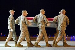 A U.S. Marine Corps carry team transfers the remains of Marine Sgt. Bradley W. Atwell, of Kokomo, Ind., at Dover Air Force Base, Del., Sept. 19, 2012. Atwell was assigned to Marine Aviation Logistics Squadron 13, Marine Aircraft Group 13, 3rd Marine Aircraft Wing, I Marine Expeditionary Force (Forward). (U.S. Air Force photo/Roland Balik)