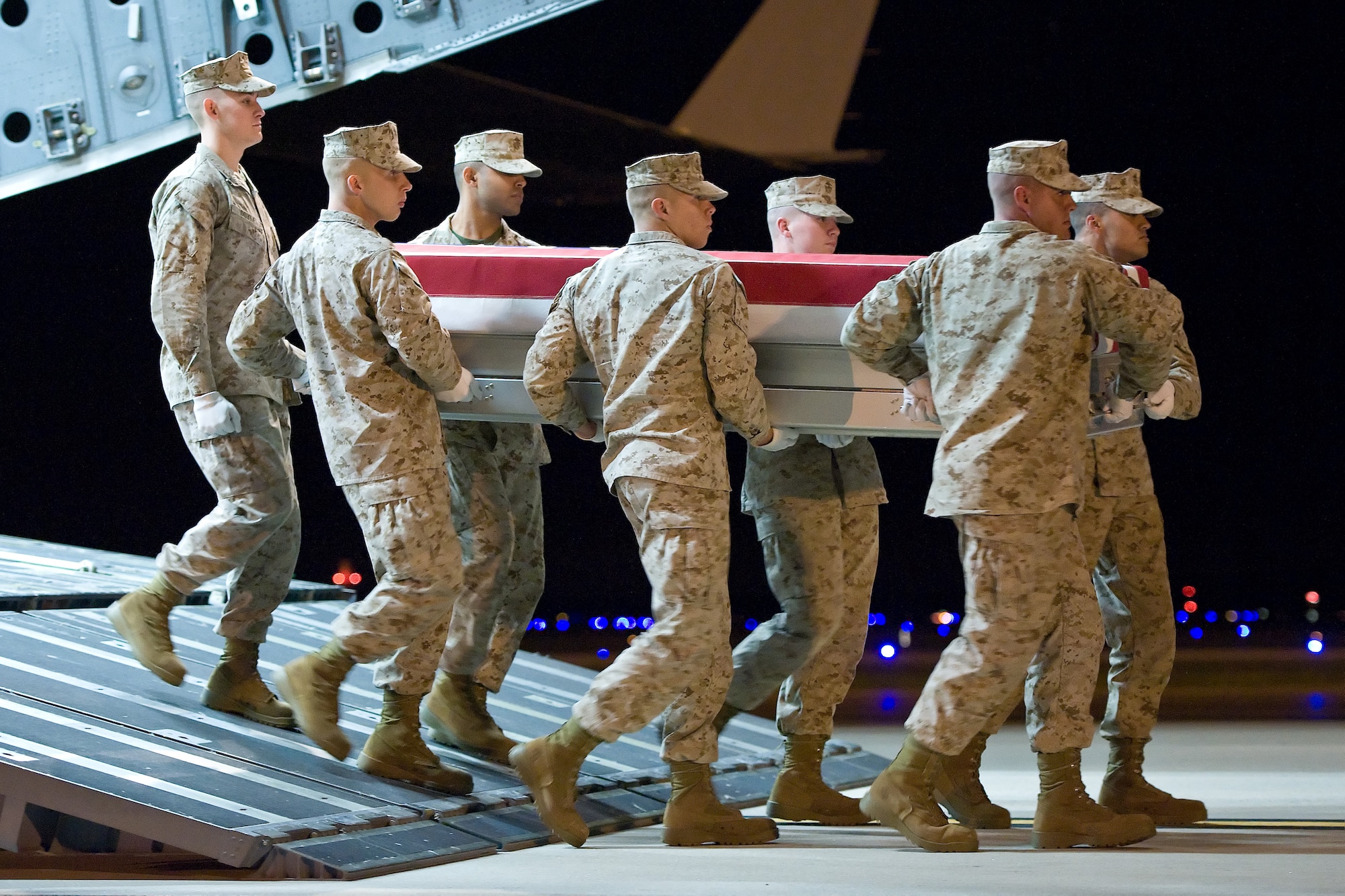 A U.S. Marine Corps carry team transfers the remains of Marine Lt. Col. Christopher K. Raible, of North Huntingdon, Pa., at Dover Air Force Base, Del., Sept. 19, 2012. Raible was assigned to Marine Attack Squadron 211, Marine Aircraft Group 13, 3rd Marine Aircraft Wing, I Marine Expeditionary Force (Forward). (U.S. Air Force photo/Roland Balik)