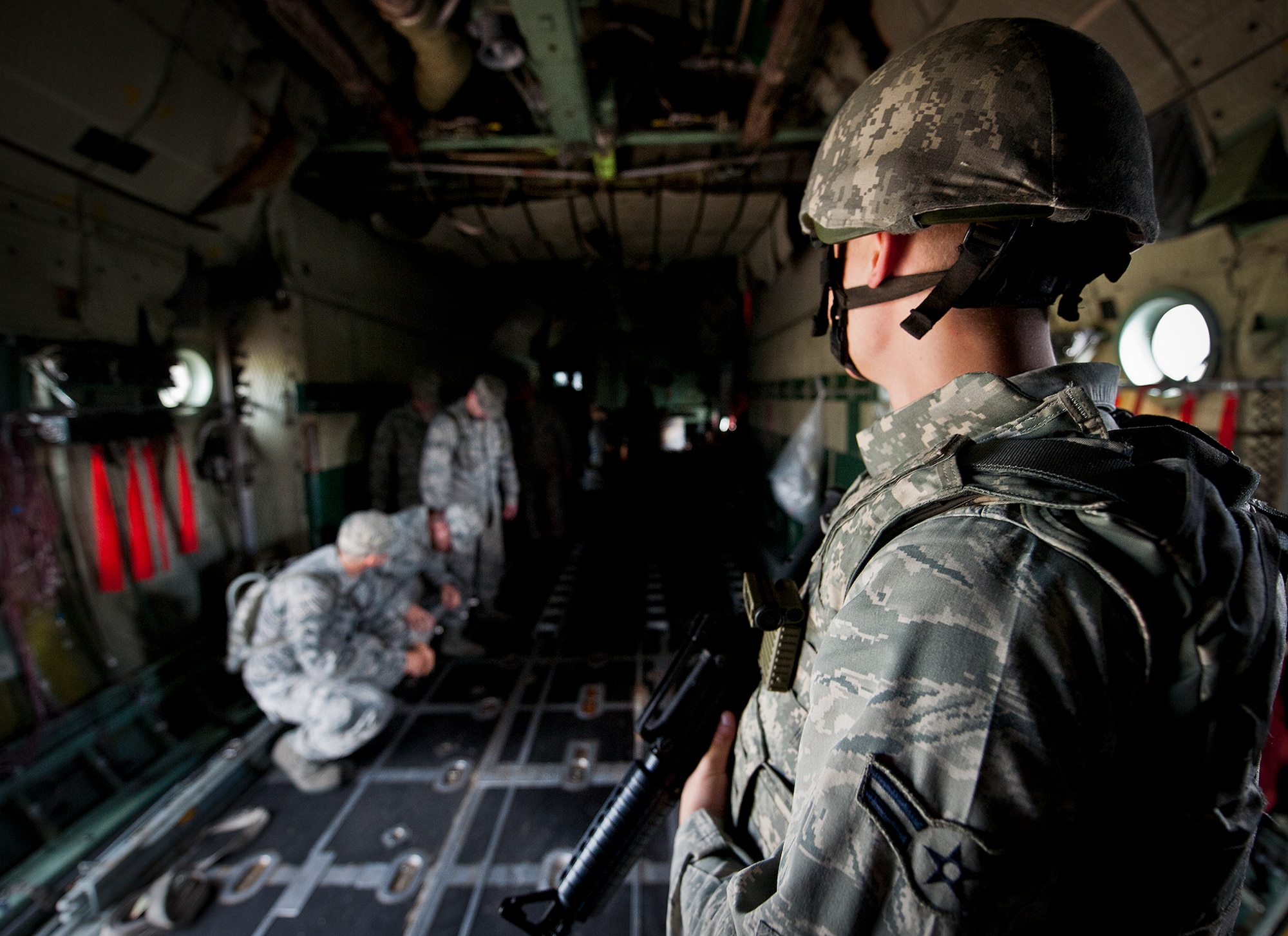 An Airman stands guard as simulated passengers board the aircraft during a Fly Away Security Team training session Sept. 17 at Eglin Air Force Base, Fla. The course, taught by 96th Ground Combat Training Squadron instructors, brought together security forces Airmen from McConnell AFB, Kansas and Grand Forks AFB, N.D., to learn how to protect aircraft and handle a potential hostile situation.  (US. Air Force photo/Samuel King Jr.)