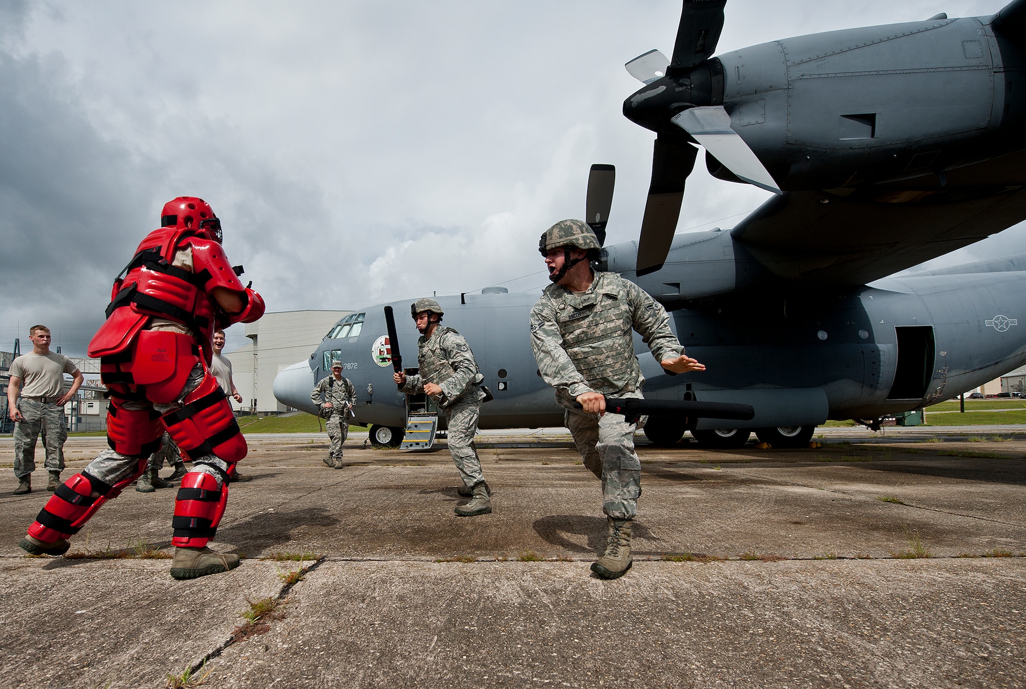 Staff Sgt. Aaron Lathrop, of the 22nd Security Force Squadron (left) and Airman 1st Class Brandon Smith, of the 319th Security Forces Squadron, move in to take down an enemy combatant during a Fly Away Security Team training session Sept. 17 at Eglin Air Force Base, Fla. The course, taught by 96th Ground Combat Training Squadron instructors, brought together security forces Airmen from McConnell AFB, Kansas and Grand Forks AFB, N.D., to learn how to protect aircraft and handle a potential hostile situation.  (U.S. Air Force photo/Samuel King Jr.)