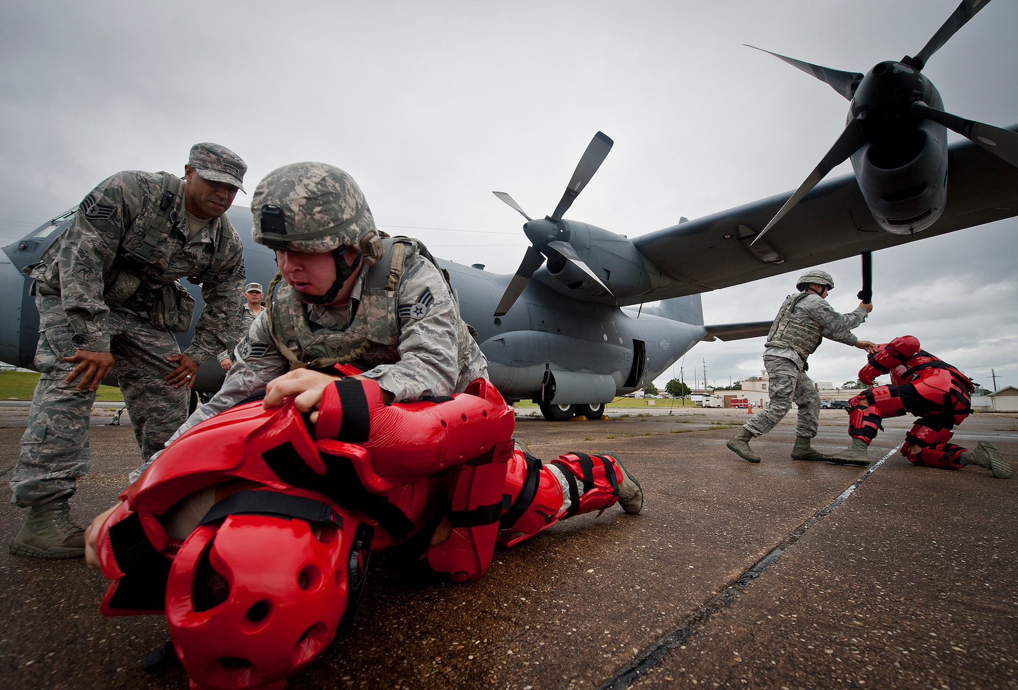 Senior Airman Jonathan Hogg (left), of the 319th Security Forces Squadron, subdues an enemy combatant, as 96th Ground Combat Squadron instructors watch during a Fly Away Security Team training session Sept. 17 at Eglin Air Force Base, Fla. The course, taught by 96th Ground Combat Training Squadron instructors, brought together security forces Airmen from McConnell AFB, Kansas and Grand Forks AFB, N.D., to learn how to protect aircraft and handle a potential hostile situation.  (U.S. Air Force photo/Samuel King Jr.)