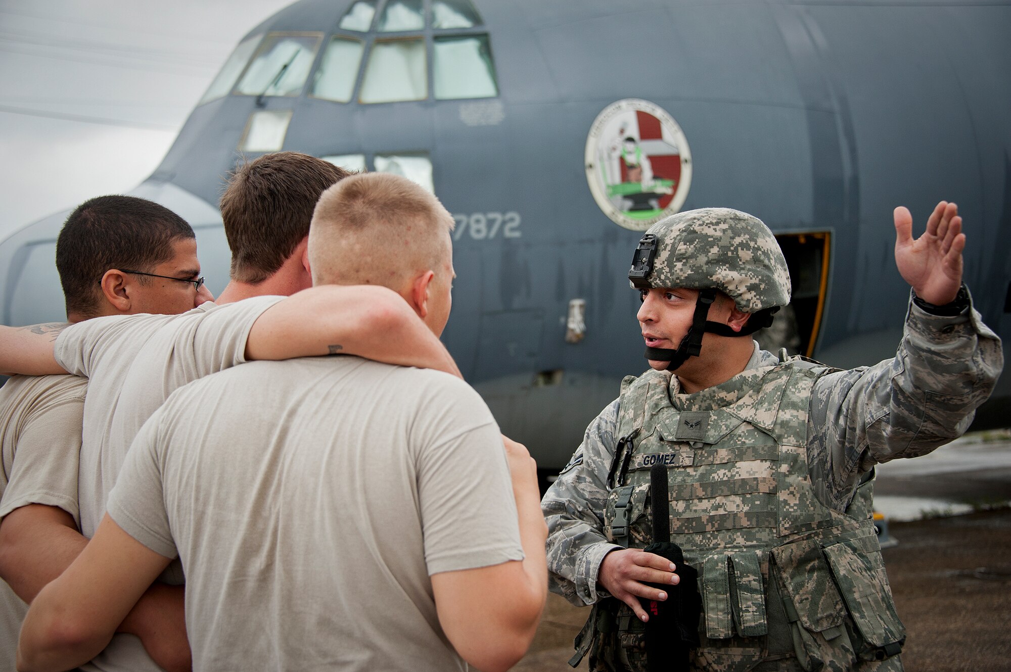 Airman 1st Class Oscar Gomez-Villatoro, of the 319th Security Forces Squadron, talks with simulated foreign nationals during a Fly Away Security Team training session Sept. 17 at Eglin Air Force Base, Fla. The course, taught by 96th Ground Combat Training Squadron instructors, brought together security forces Airmen from McConnell AFB, Kansas and Grand Forks AFB, N.D., to learn how to protect aircraft and handle a potential hostile situation.  (U.S. Air Force photo/Samuel King Jr.)
