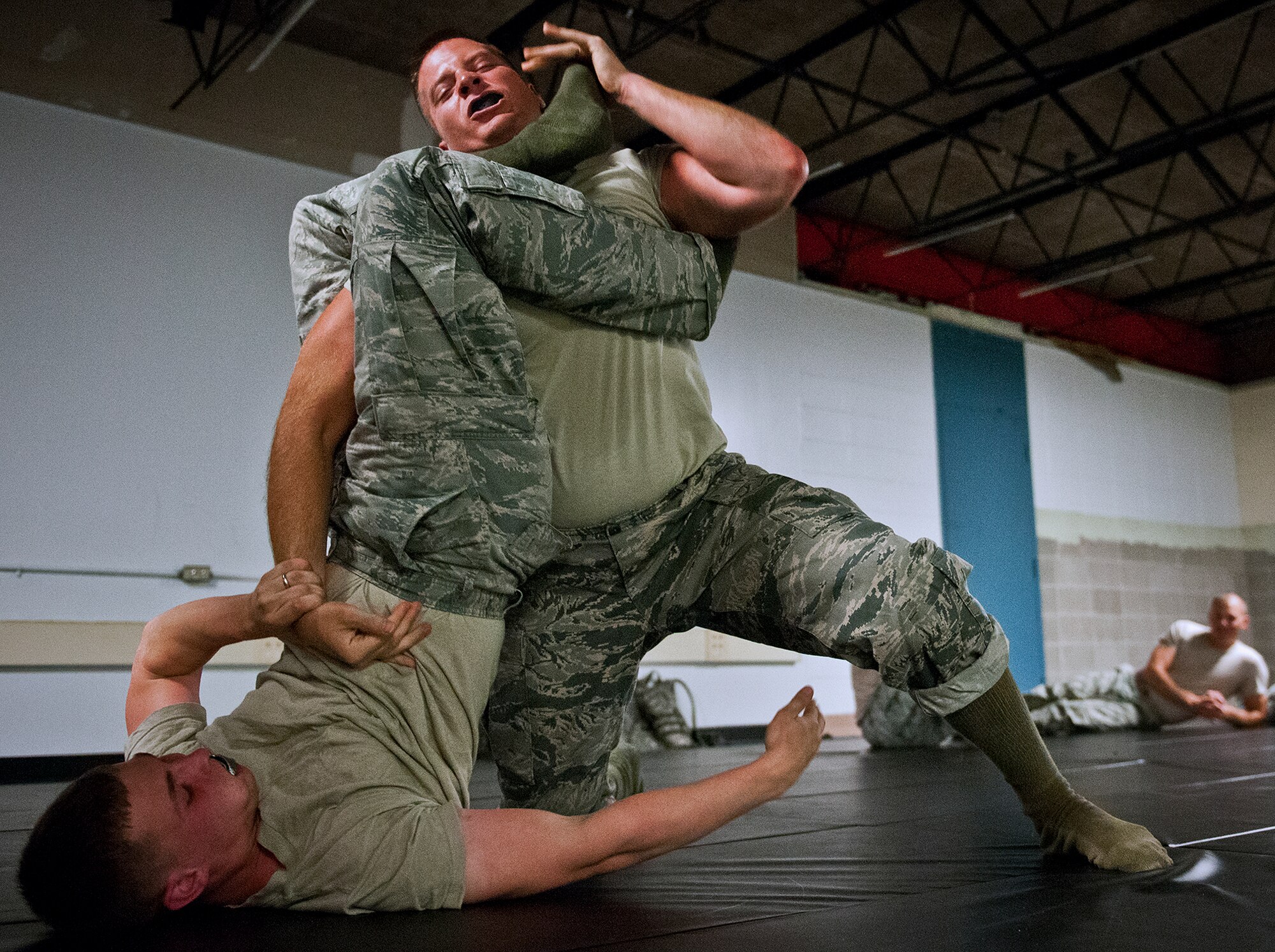 Security Forces Airmen grapple for control during the “King of the Mat” competition at Eglin Air Force Base, Fla., Sept. 17.  The competition is part of their “Brave Defender” deployment training.  The Airmen take the skills and techniques learned during their combatives course and put them into practice against one another.The course, taught by 96th Ground Combat Training Squadron instructors, brought together security forces Airmen from McConnell AFB, Kansas and Grand Forks AFB, N.D., to learn how to protect aircraft and handle a potential hostile situation.  (U.S. Air Force photo/Samuel King Jr.)
