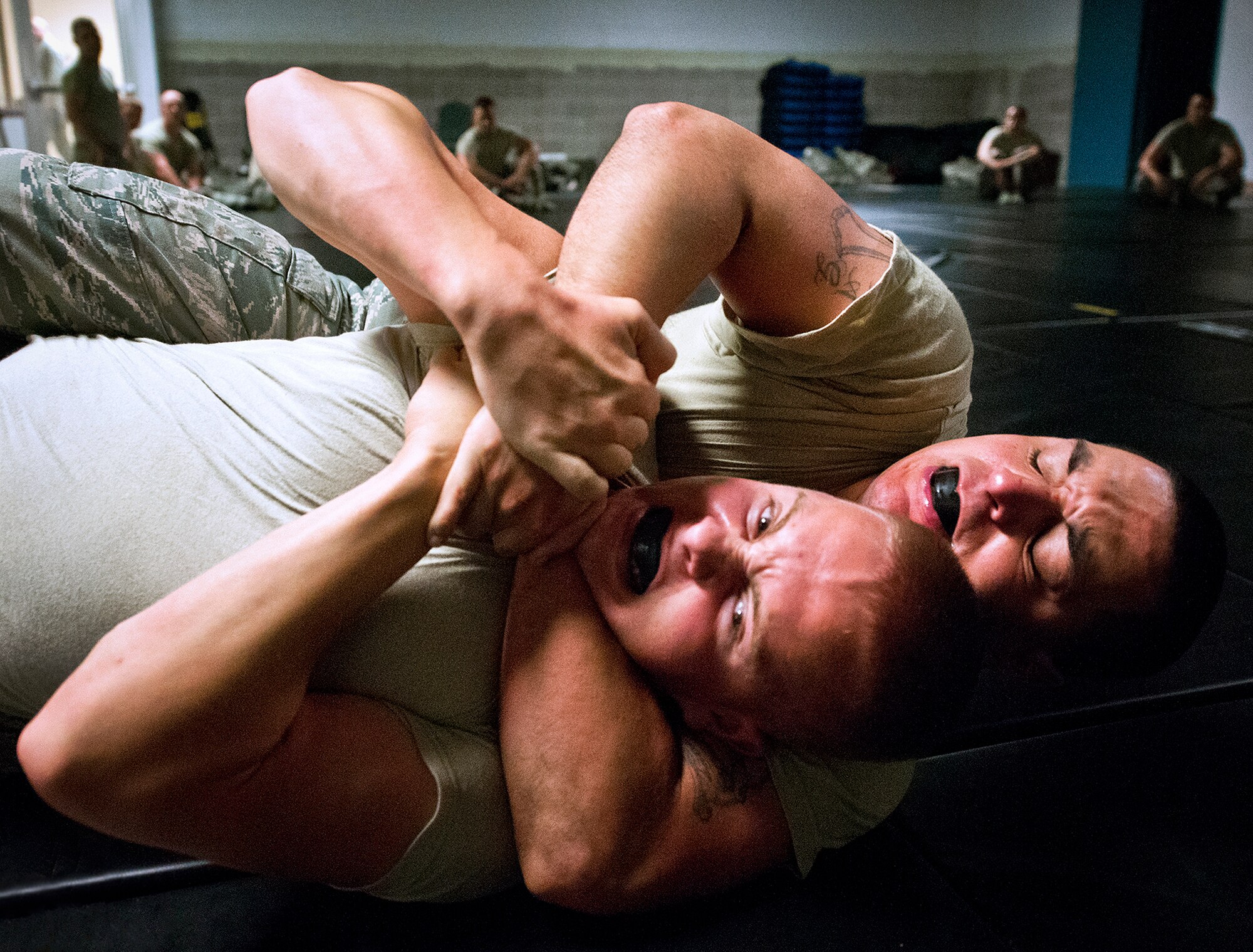 Airman 1st Class Oscar Gomez-Villatoro, of the 319th Security Forces Squadron, puts his opponent in a choke hold during the “King of the Mat” competition at Eglin Air Force Base, Fla., Sept. 17.  The competition is part of their “Brave Defender” deployment training.  The Airmen take the skills and techniques learned during their combatives course and put them into practice against one another. The training is administered by the 96th Ground Combat Training Squadron.  More than 1,400 Airmen from across the Air Force attend the three-week courses each year. (U.S. Air Force photo/Samuel King Jr.)