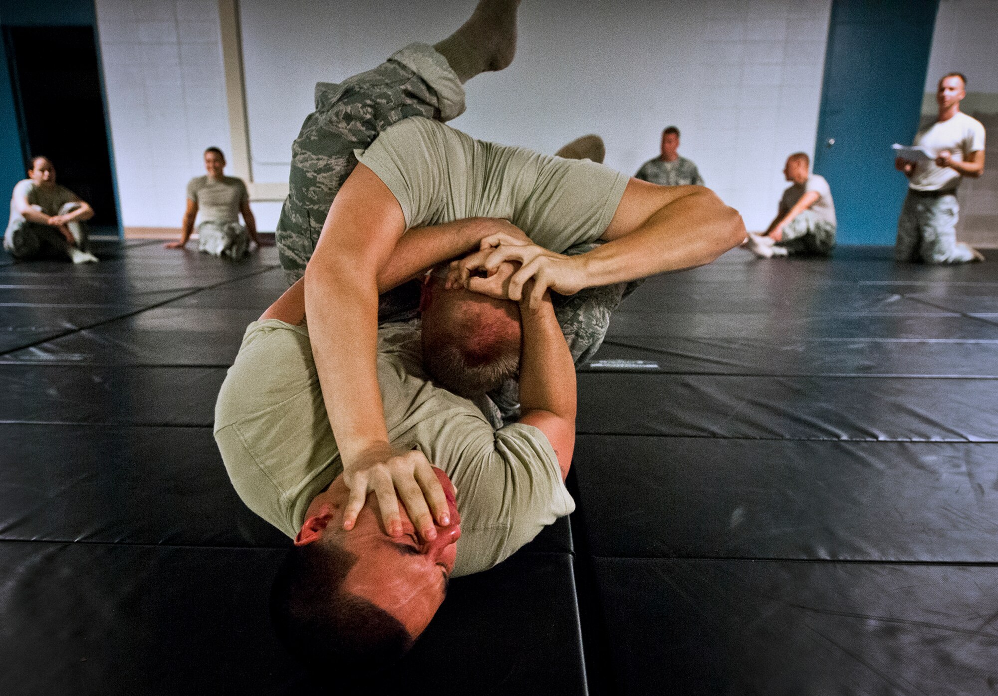 Security Forces Airmen grapple for control during a “King of the Mat” competition training at Eglin Air Force Base, Fla., Sept. 17.  The Airmen take the skills and techniques learned during their combatives course and put them into practice against one another as part of their “Brave Defender” deployment training.  The training is administered by the 96th Ground Combat Training Squadron.  More than 1,400 Airmen from across the Air Force attend the three-week courses each year. (U.S. Air Force photo/Samuel King Jr.)