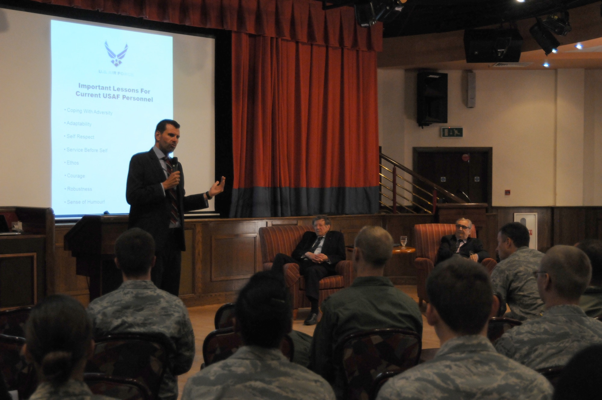 RAF Mildenhall, England - Dr. Howard Tuck, a historian, speaks during a prisoner-of-war/missing-in-action interactive presentation at RAF Mildenhall, England, Sept. 19, 2012. Also speaking during the event were retired RAF Air Cdre Charles Clarke and Andy Wiseman, both former prisoners of war during World War II who were held captive in the German prison camp Stalag Luft III. They visited Mildenhall to share their stories during POW/MIA remembrance week. (U.S. Air Force photo/Tech. Sgt. Neal X. Joiner) 