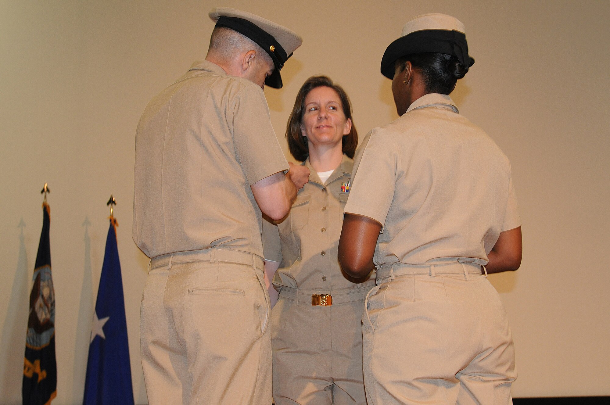 U.S. Navy Chief Petty Officer Shawna Houser looks at her fellow Shipmates while being pinned with the new rank. Members from Class 119 are the first Chief Petty Officer?s to be pinned here at the 379th Air Expeditionary Wing during the inaugural Chief Petty Officer Pinning Ceremony in Southwest Asia, September 14, 2012. (U.S. Air Force photo/Capt. Craig Carper)