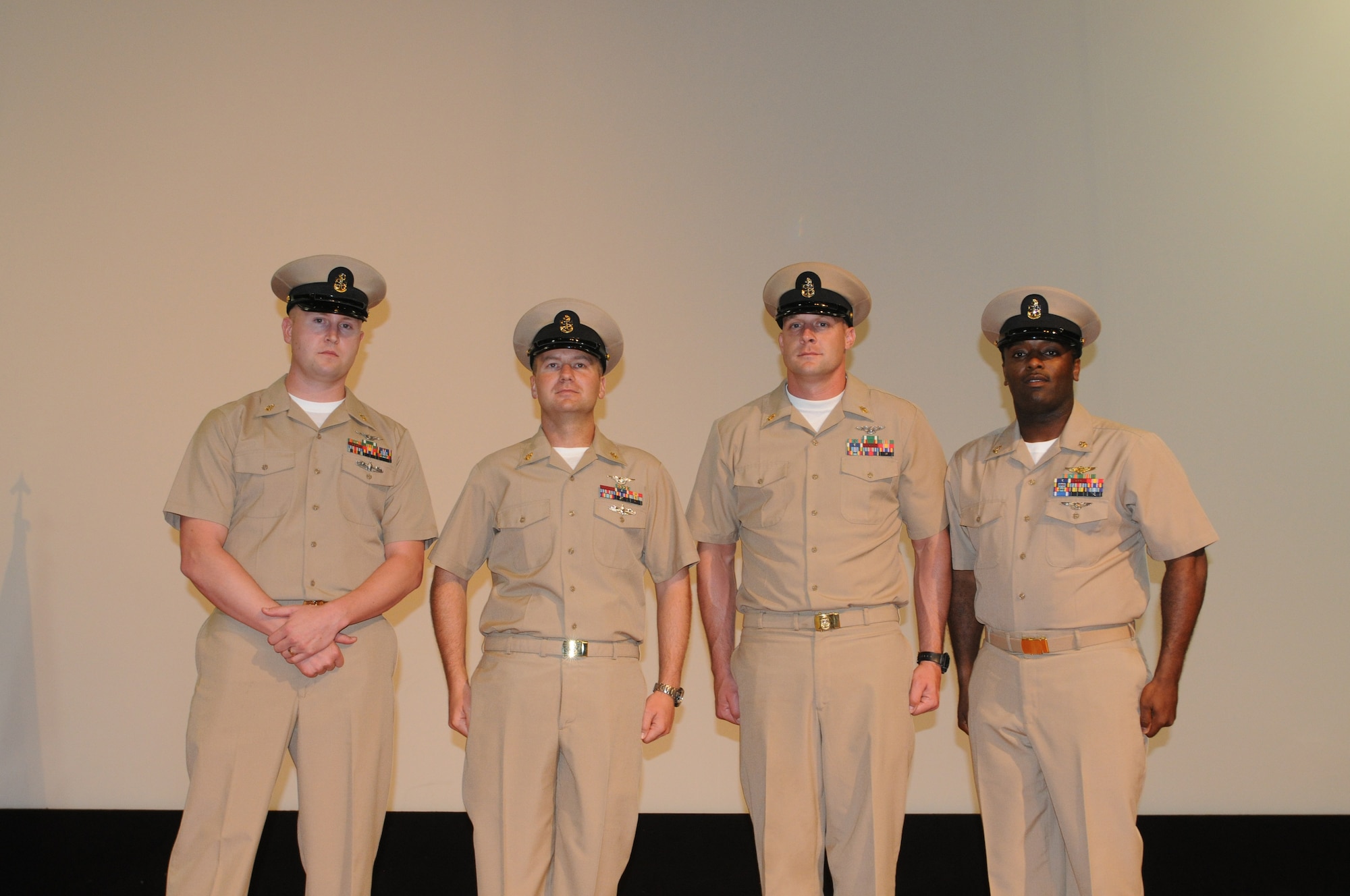 U.S. Navy Chief Petty Officers (left to right) Joe Hudson, Anh Le, Jason Lacy, and Curtis Jackson pose for the camera during the Chief Petty Officer Pinning Ceremony in Southwest Asia, September 14, 2012. (U.S. Air Force photo/Capt. Craig Carper)