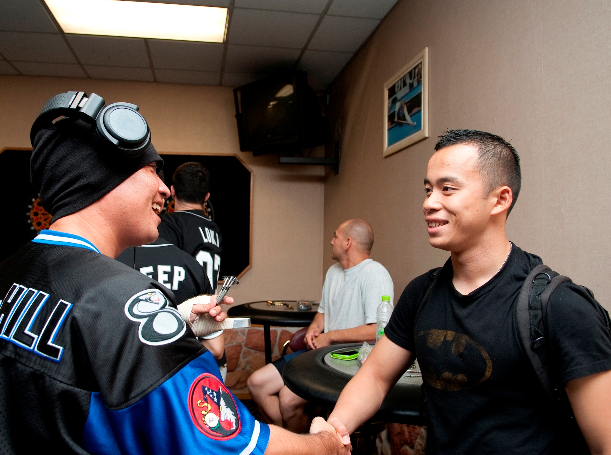 Senior Airman Charles Sothikhoun, right, makes his daily rounds with his backpack at Kunsan Air Base, Republic of Korea, Sept. 20, 2012. Dubbed as Kunsan’s unofficial Wingman, he said his goal in helping people is to make sure nobody gets in trouble, is forgotten or left alone. (U.S. Air Force photo/Senior Airman Brigitte N. Brantley)