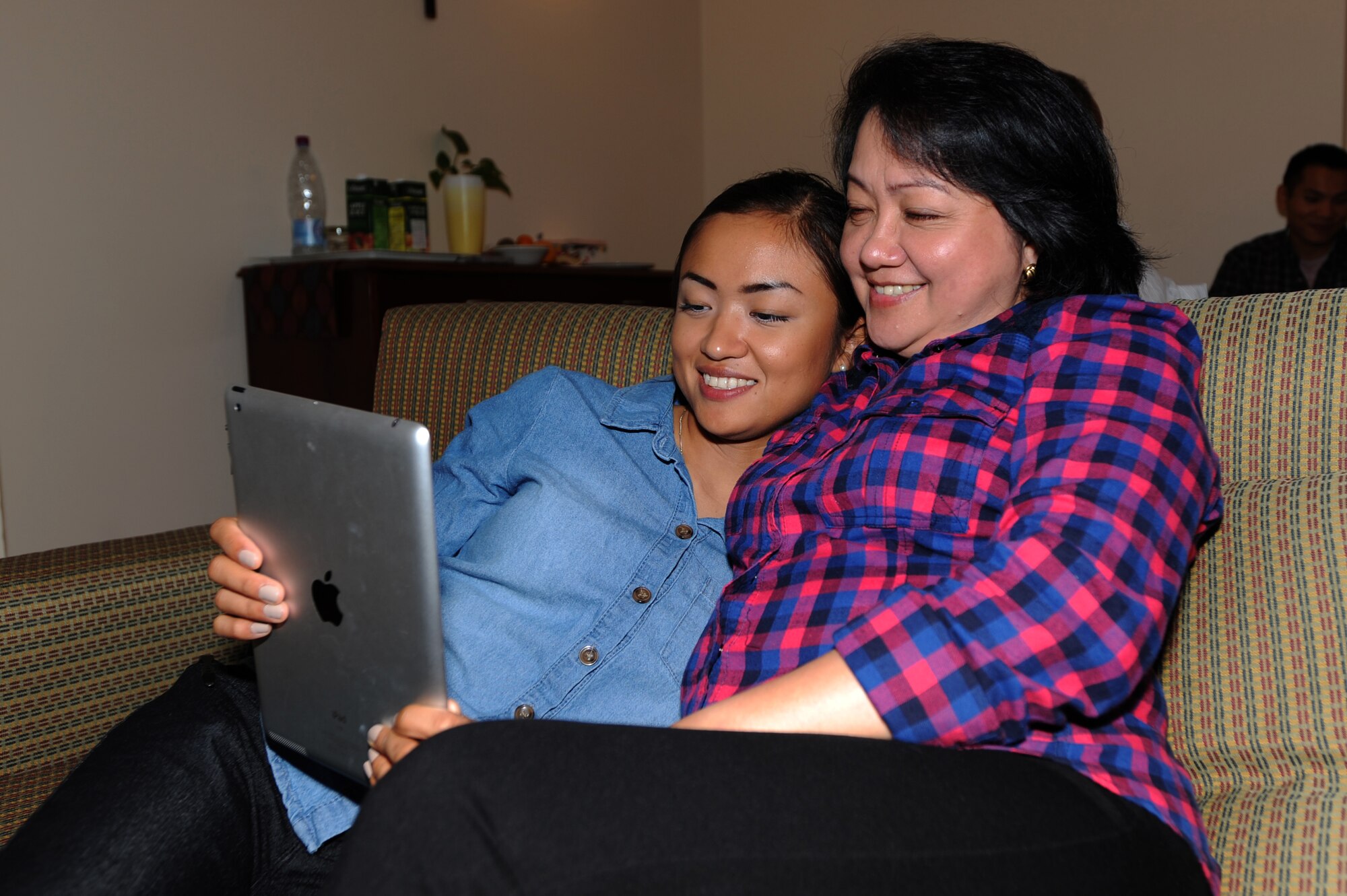 U.S. Air Force Senior Airman Joyce Tucker, 379th Expeditionary Civil Engineer Squadron construction site manager, visits with her grandmother, Lolly Pagdanganan, after meeting her grandparents for the first time in 22 years while deployed in Southwest Asia, September 5, 2012. (U.S. Air Force photo/Staff Sgt. Sheila deVera)