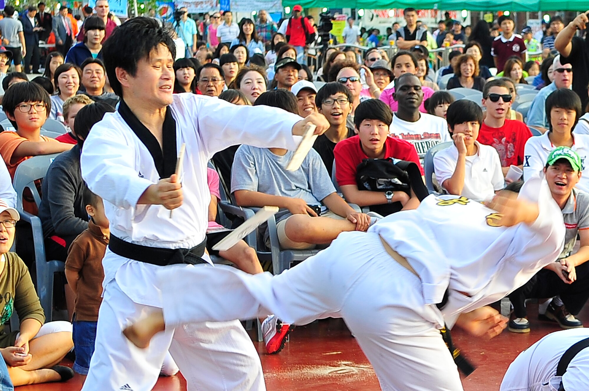 Taekwondo practitioners demonstrate their martial arts skills during the Korean American Friendship Festival Sept. 15, 2012. The two-day event just outside of Osan Air Base, Republic of Korea, featured American and Korean stage performers, martial arts demonstrations, cultural food and entertainment booths. (U.S. Air Force photo/Tech. Sgt. Raymond Mills)
