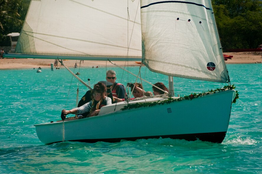 Connie Guthrie, daughter Louis “Papa Lou” Foster, a retired Air Force master sergeant, and creator of Hickam Harbor, spreads her father’s ashes in the waters near Foster Point Sept. 1, at Joint Base Pearl Harbor-Hickam, Hawaii. Founder of the Wets Hens, an all-female sailing club at Hickam, Foster is best known for his sailing skills. He died in his hometown of Eagle Point, Ore., at the age of 90. (U.S Air Force photo/Staff Sgt. Mike Meares)