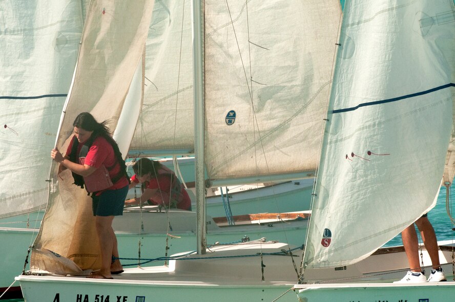 Members of the Wet Hens, a sailing group founded by Louis “Papa Lou” Foster, a retired Air Force master sergeant, and creator of Hickam Harbor, prepare the sails for a ceremonial voyage around Hickam Harbor, Sept. 1 at Joint Base Pearl Harbor-Hickam, Hawaii. Founder of the Wets Hens Foster is best known for his sailing skills. He died in his hometown of Eagle Point, Ore., at the age of 90. (U.S Air Force photo/Staff Sgt. Mike Meares)