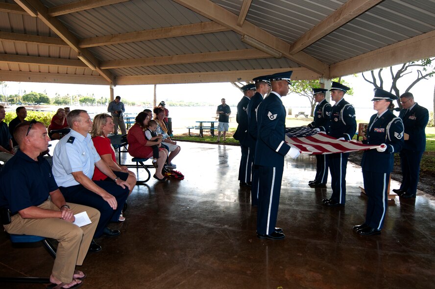 The Hickam Honor Guard folds a flag during the memorial ceremony for Louis “Papa Lou” Foster, a retired Air Force master sergeant, and creator of Hickam Harbor, at Foster Point, Sept. 1 at Joint Base Pearl Harbor-Hickam, Hawaii. Founder of the Wets Hens, an all-female sailing club at Hickam, Foster is best known for his sailing skills. He died in his hometown of Eagle Point, Ore., at the age of 90. (U.S Air Force photo/Staff Sgt. Mike Meares)