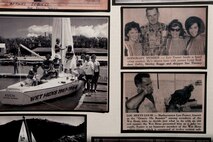 Newspaper clippings on a display board honor the accomplishments of Louis “Papa Lou” Foster, a retired Air Force master sergeant, and creator of Hickam Harbor, during a memorial ceremony at Foster Point, Sept. 1 at Joint Base Pearl Harbor-Hickam, Hawaii. Founder of the Wets Hens, an all-female sailing club at Hickam, Foster is best known for his sailing skills. He died in his hometown of Eagle Point, Ore., at the age of 90. (U.S Air Force photo/Staff Sgt. Mike Meares)