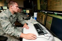 Airman 1st Class Derrick Smit, 17th Operational Weather Squadron weather technician, monitors two typhoons south of Japan Aug. 23, at the Pacific Air Forces Headquarters, Joint Base Pearl Harbor-Hickam, Hawaii. The 17th OWS recently completed a standardization and evaluation program for weather operations, or SEPWO, inspection where they scored 214 out of a possible 215 points, for a 99.53 percent passing score. Members of the squadron had to pay up on a shaving bet when they scored higher than 97 percent, including more than 75 years of continuous mustache growth. (U.S. Air Force photo/Staff Sgt. Mike Meares)
