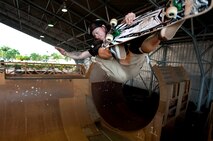 U.S. Army Sgt. Chris Gray, 82nd Engineer Support Company, Schofield Barracks, Hawaii, catches some air while skating at the Hickam Skate Hangar, Aug. 23, at Joint Base Pearl Harbor-Hickam, Hawaii. The converted hangar is the only indoor wooden facility on all the Hawaiian Islands. It also boasts the only wooden keyhole bowls, or empty swimming pool shaped ramps, on Oahu. In addition, it has a 15,000 square foot street course, multiple mini ramps, 12-foot vertical ramp with a 14-foot tombstone connected to a saddle and three-quarter pipe. (U.S. Air Force photo/Staff Sgt. Mike Meares)
