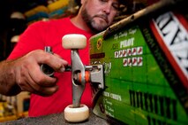 Mike Kays, operator of the Hickam Skate Hangar, repairs a skateboard inside the pro shop Aug. 22, Joint Base Pearl Harbor-Hickam, Hawaii. He has been working since the mid-1990’s to make the skate park a safe place for people to hangout and learn the art of skateboarding. The park is the only indoor wooden facility on all the Hawaiian Islands. (U.S. Air Force photo/Staff Sgt. Mike Meares)