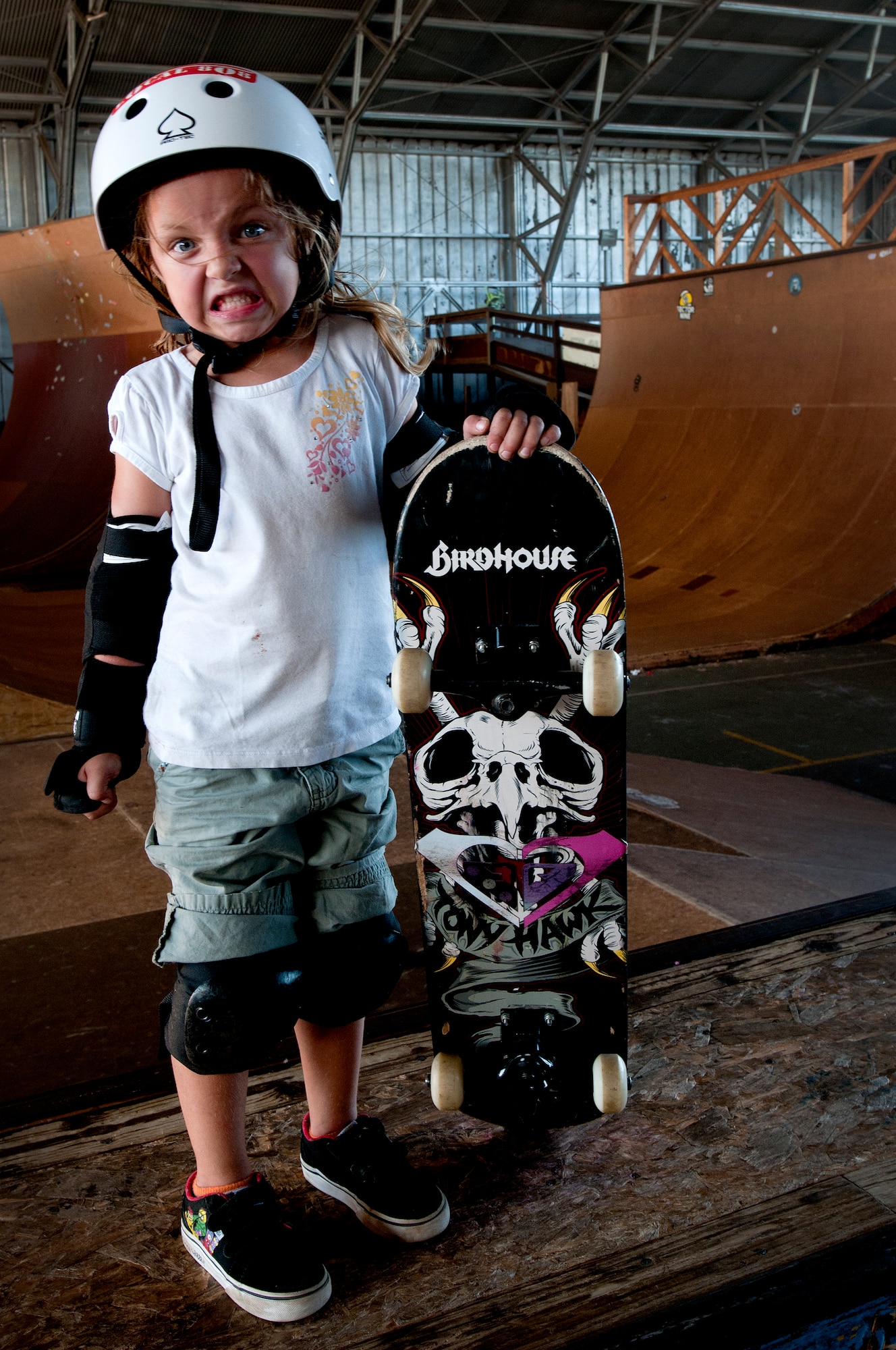 Lindsey Hawk, 5, shows how tough she is while learning to skate on a skateboard Aug. 22 at Joint Base Pearl Harbor Hickam, Hawaii. The converted hangar is the only indoor wooden facility on all the Hawaiian Islands. It also boasts the only wooden keyhole bowls, or empty swimming pool shaped ramps, on Oahu. In addition, it has a 15,000 square foot street course, multiple mini ramps, 12-foot vertical ramp with a 14-foot tombstone connected to a saddle and three-quarter pipe. (U.S. Air Force photo/Staff Sgt. Mike Meares)